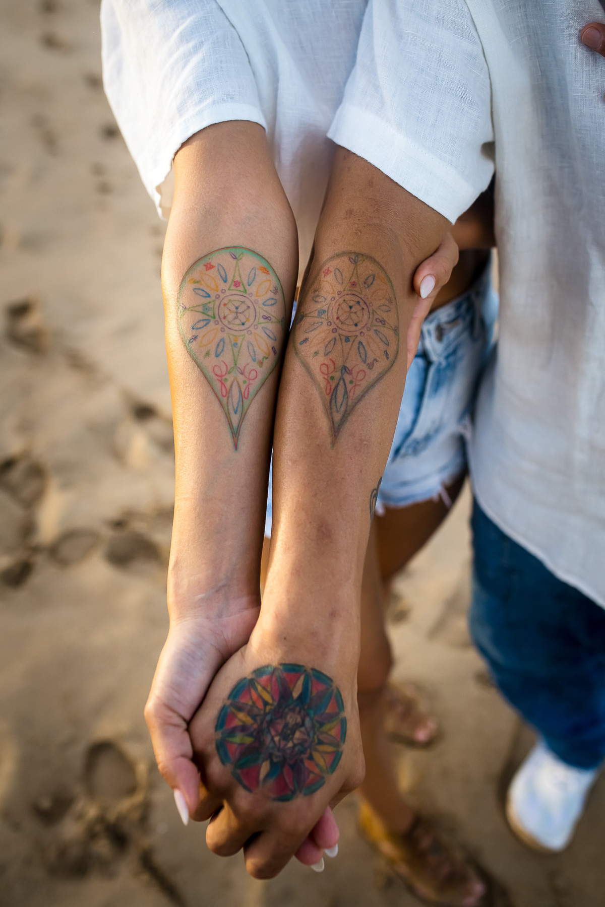 Image of matching tattoos on the arms of newly engaged couple on Kauai