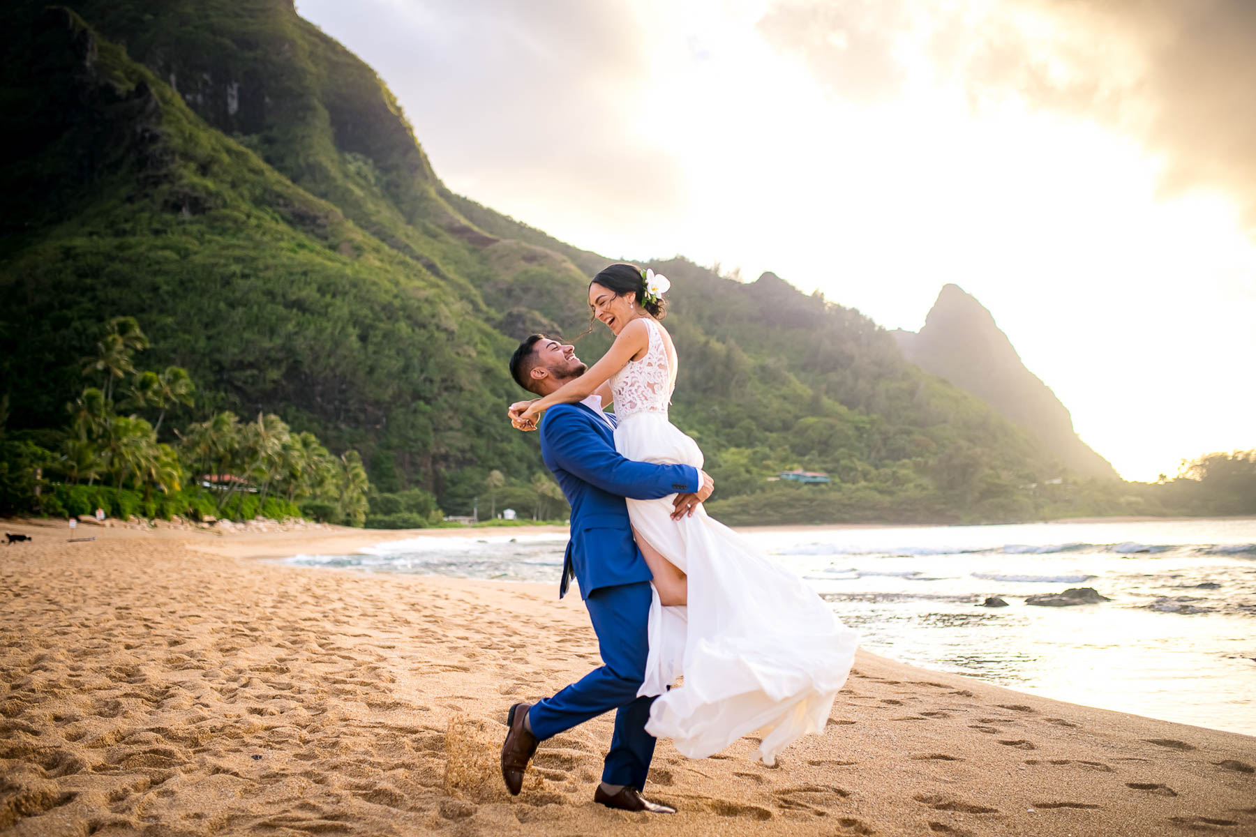 kauai wedding groom holds bride in the air