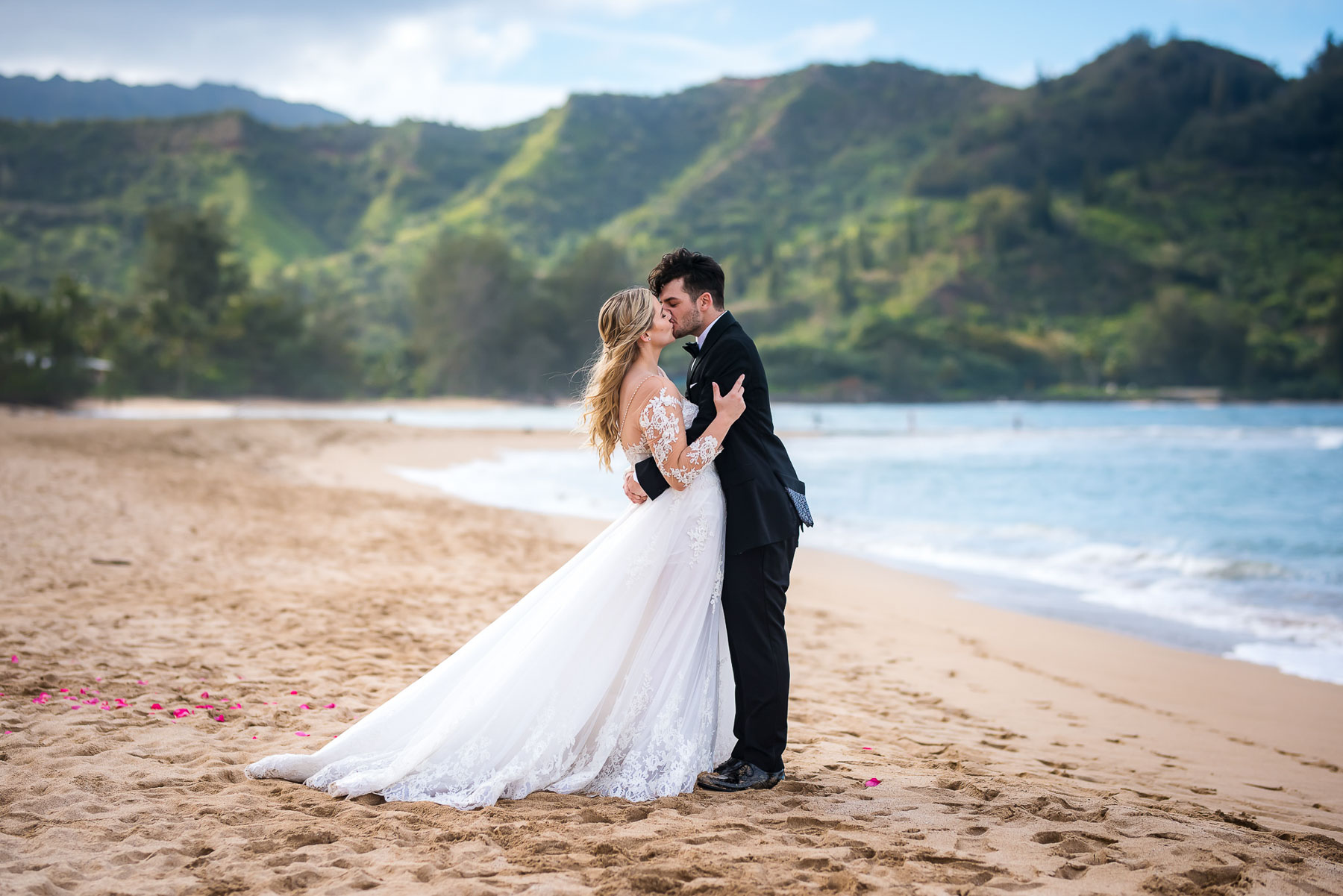 couple kissing on beach wedding in kauai