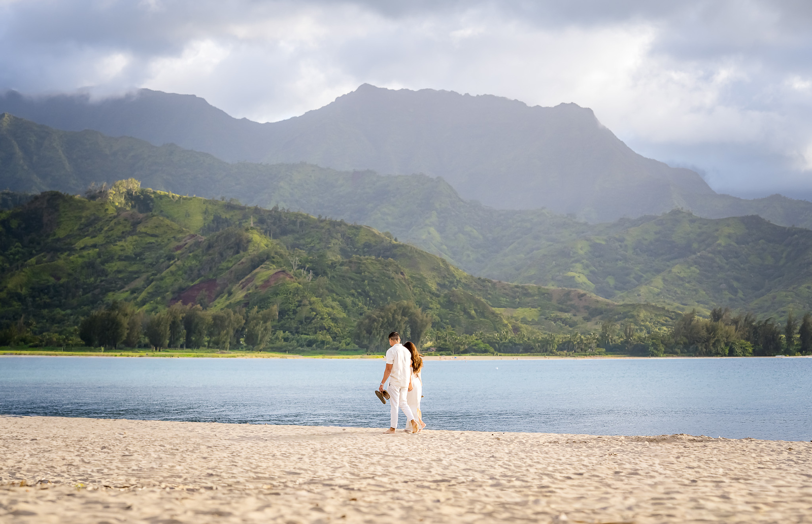 couple walking on the beach in kauai