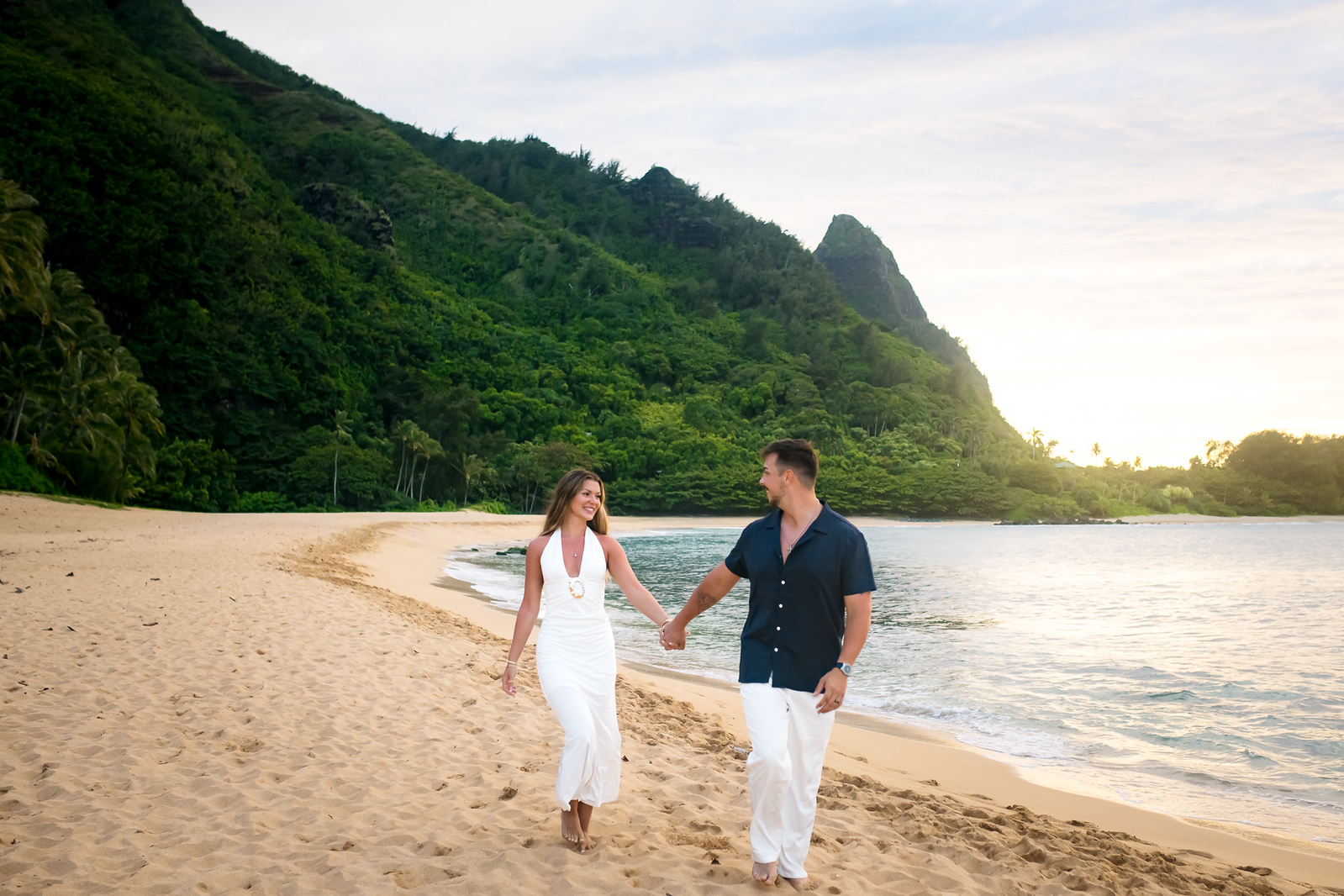 couple walking on beach after wedding kauai