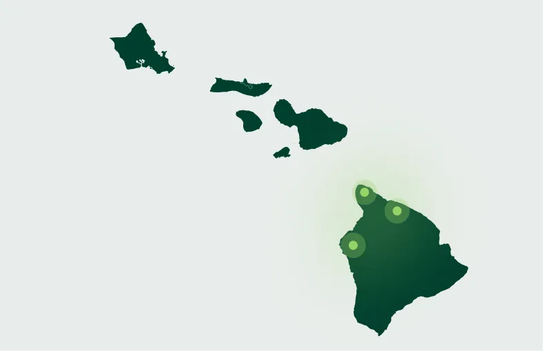 Map of the Hawaiian Islands with three glowing green dots highlighting specific locations on the largest island, Hawaii.