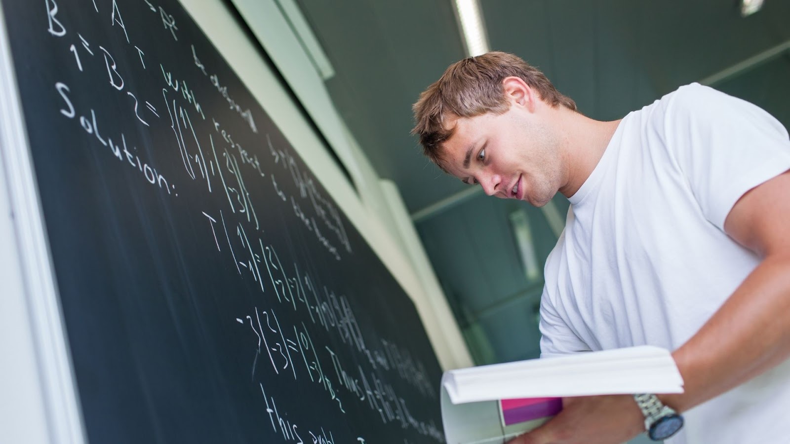 male student solving a math equation