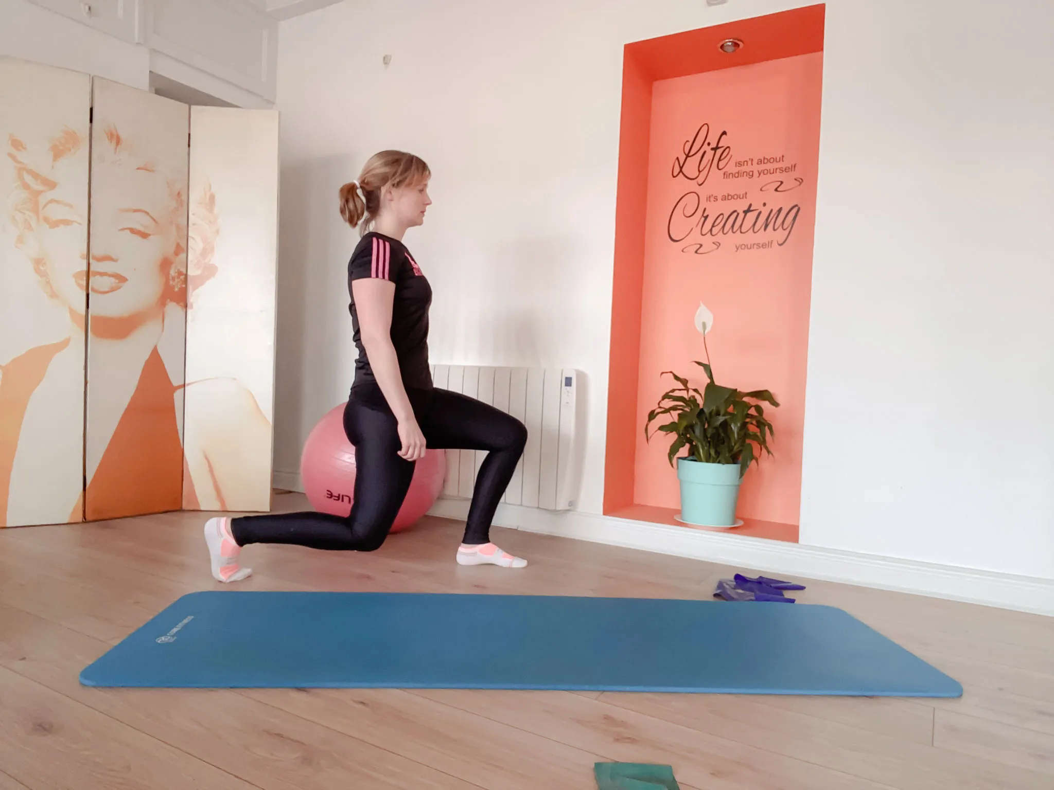 A woman is doing exercises on a yoga ball.