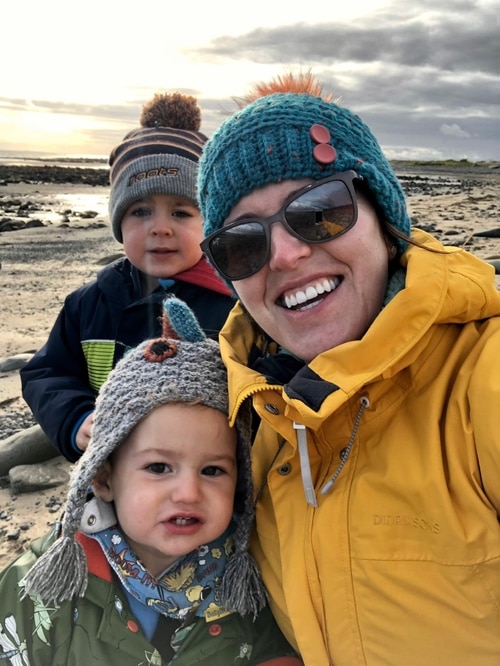 A man and two children on a beach.