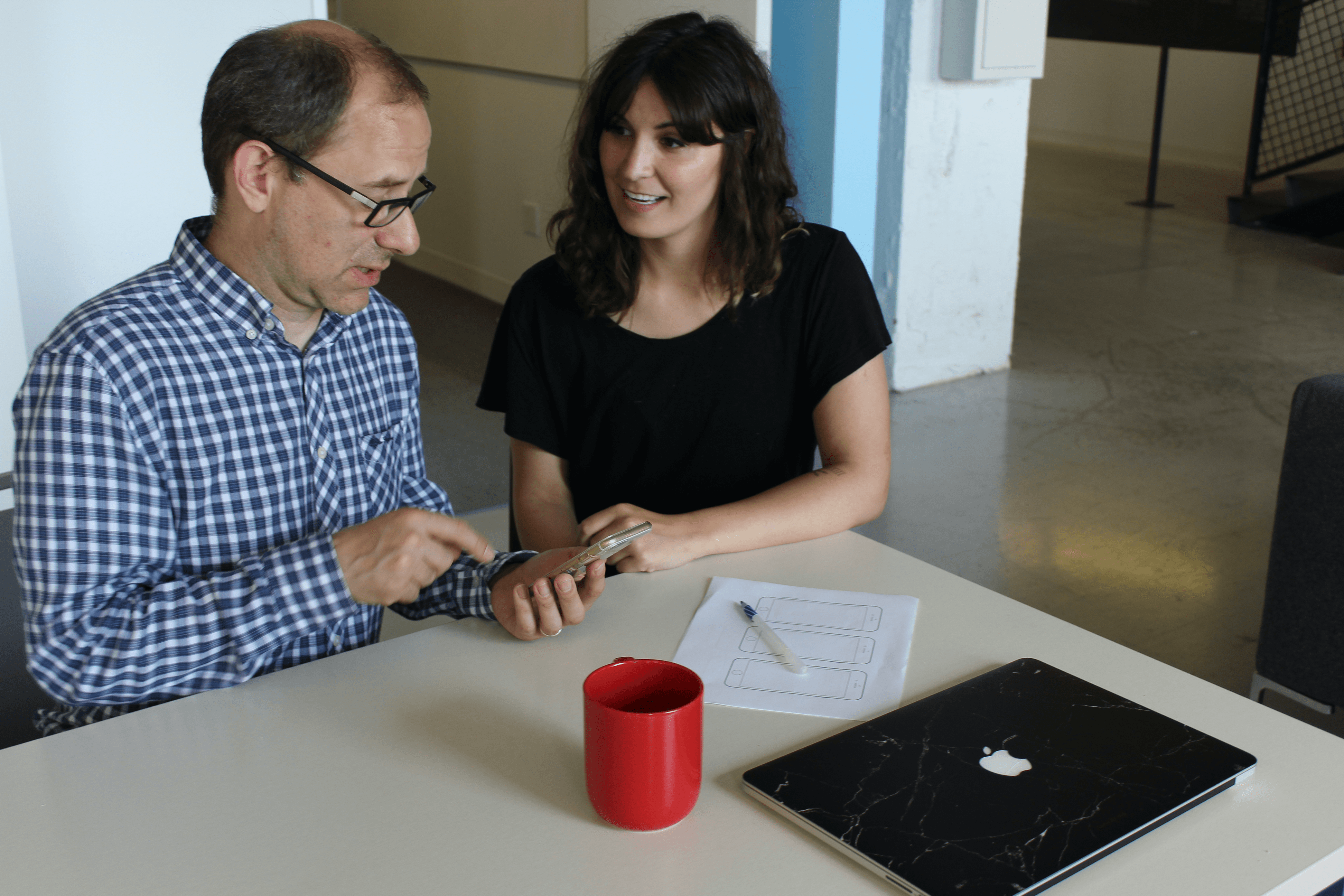 Picture of Abbigail Rose doing a usability test with a user on a mobile phone