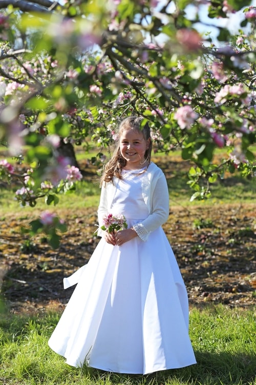 Communion girl with apple blossom trees by Jenny Callanan Photography