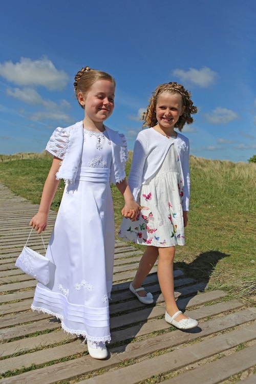 Communion girl with younger sister by Jenny Callanan Photography