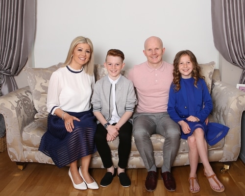 Confirmation boy with his family in their sitting room Communion boy by Jenny Callanan Photography