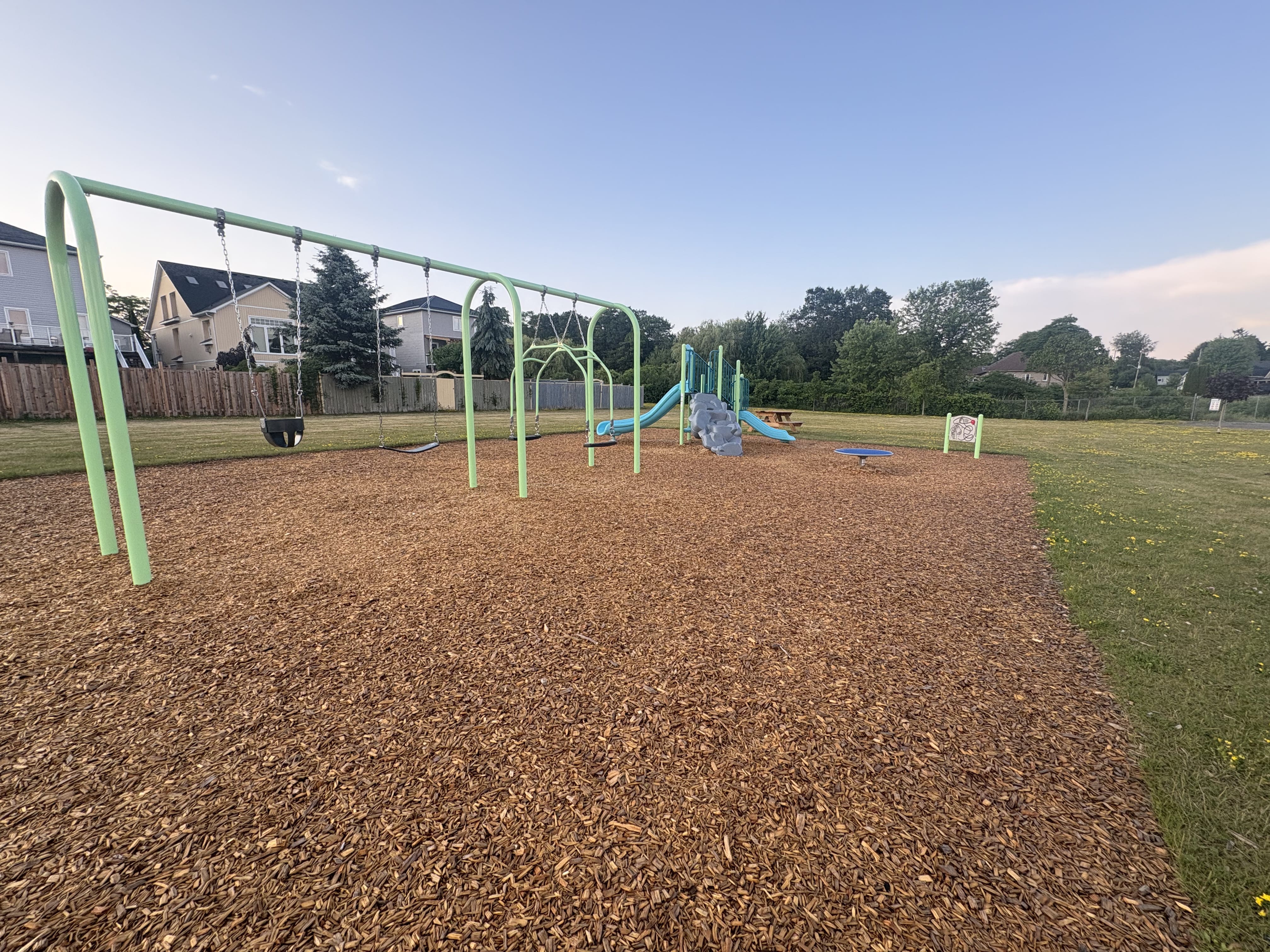 Rapley Park playground equipment in Port Hope, ON showing swing sets and climbing areas