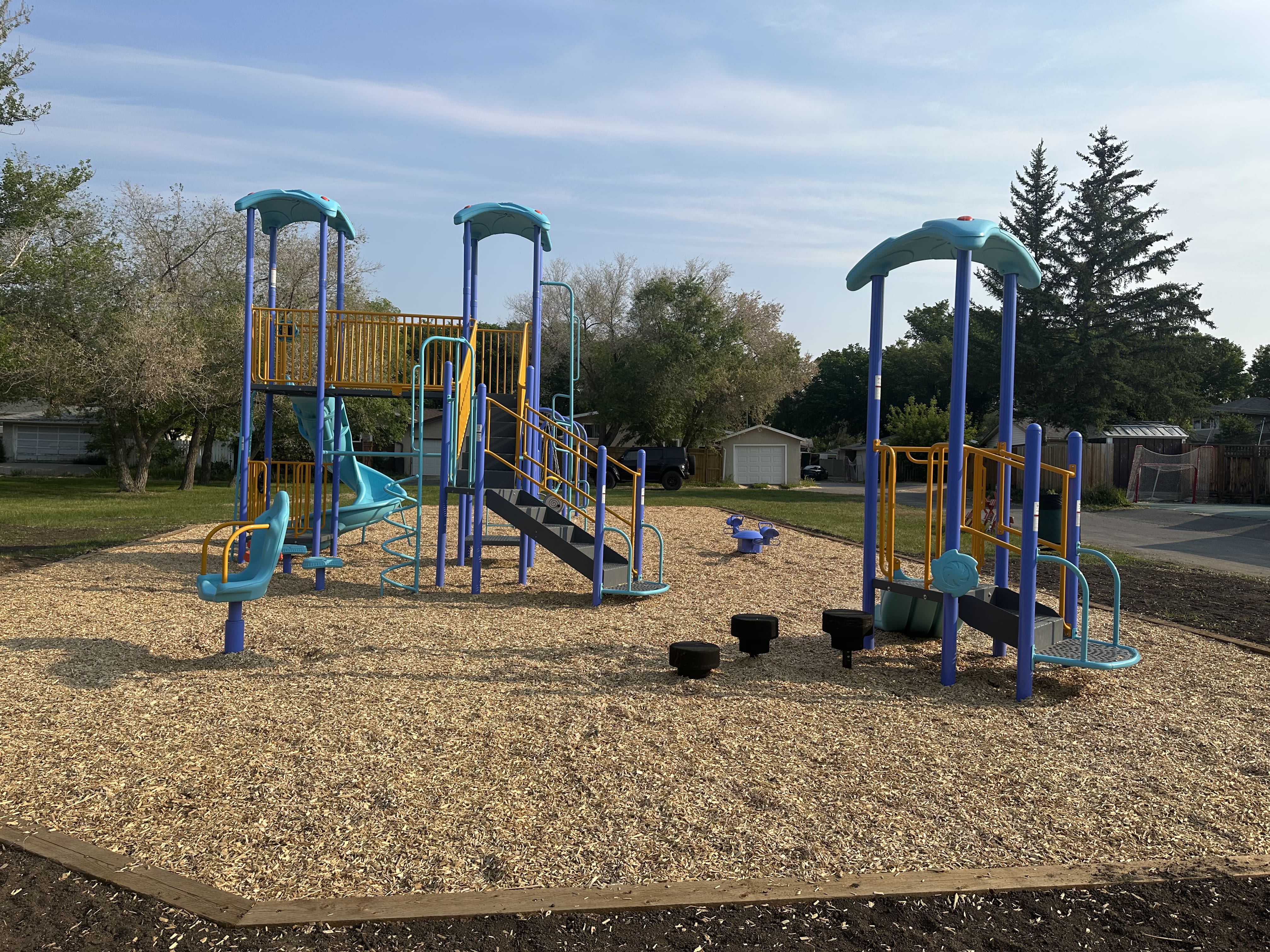 Dalgliesh Park playground in Regina featuring spiral slide and accessible play structures
