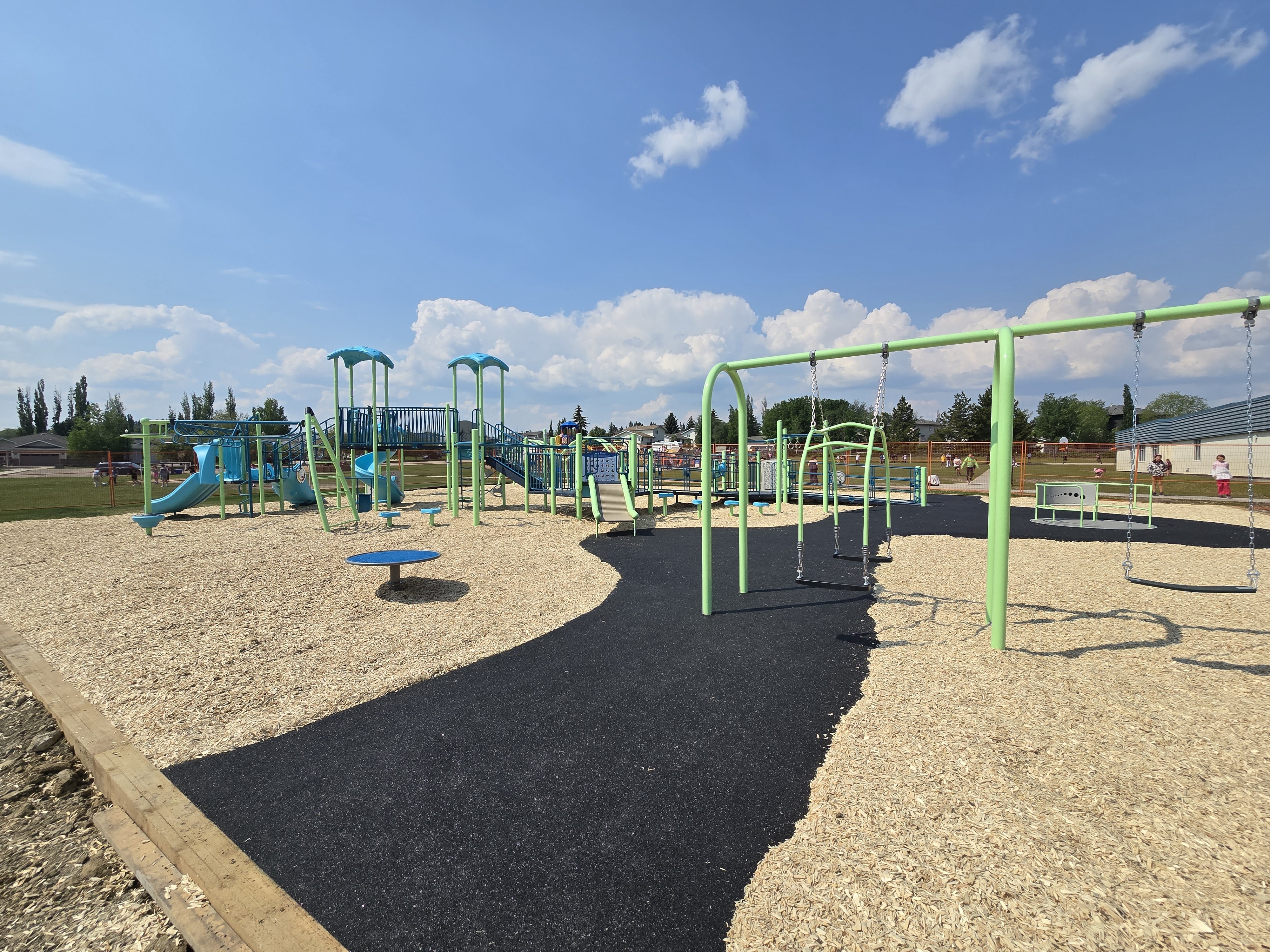 Steffie Woima Elementary School playground equipment in Sylvan Lake, AB featuring colorful play structures
