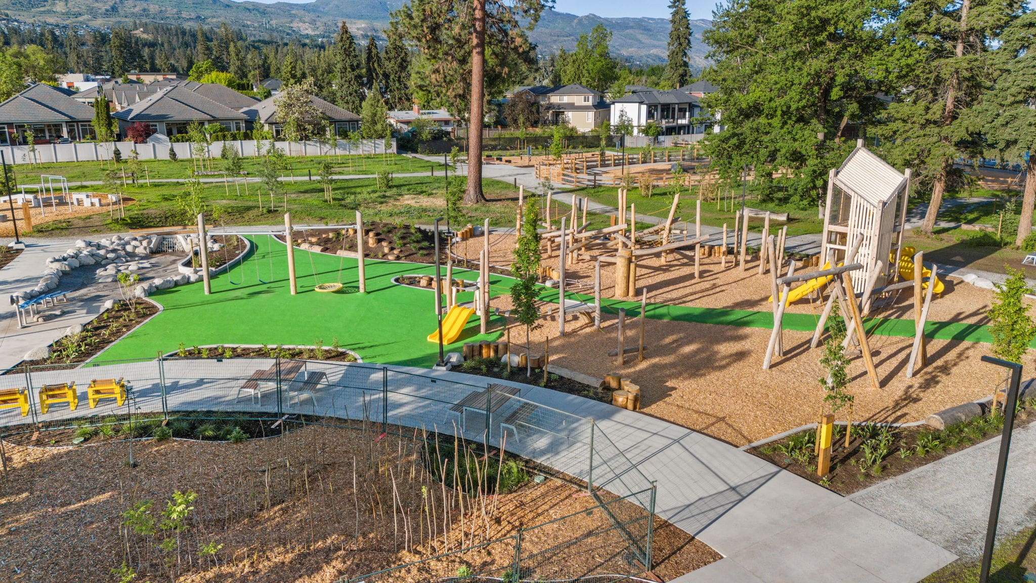 DeHart Community Park playground equipment in Kelowna, BC with safety surfacing and equipment