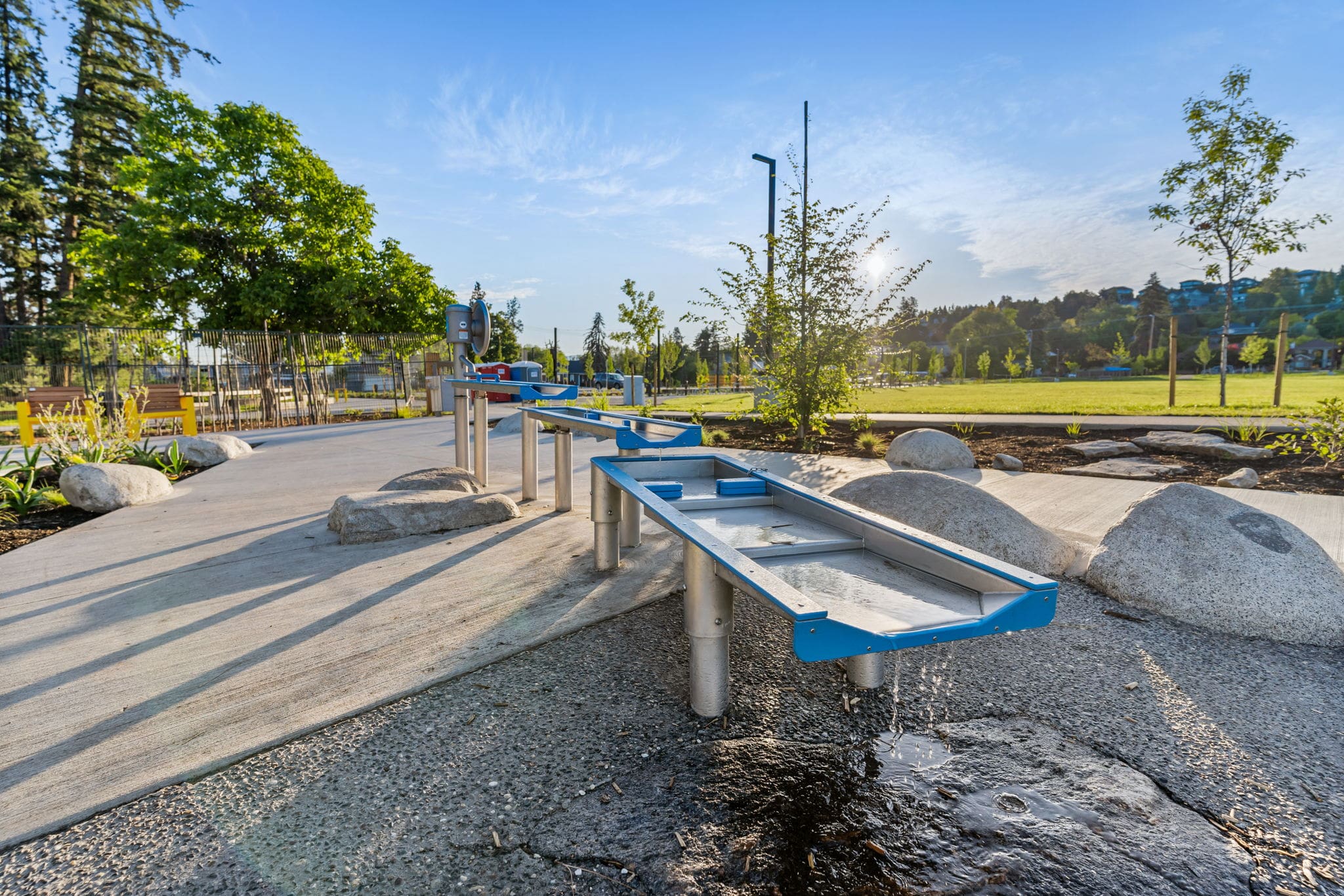 DeHart Community Park playground equipment in Kelowna, BC featuring slides and activity panels