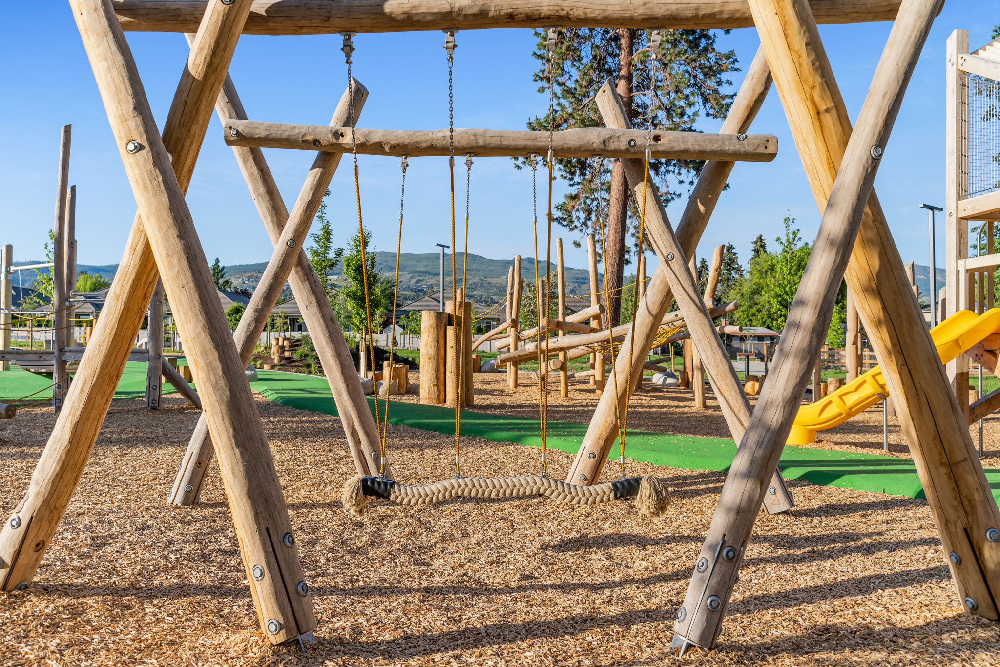 DeHart Community Park playground equipment in Kelowna, BC featuring community playground