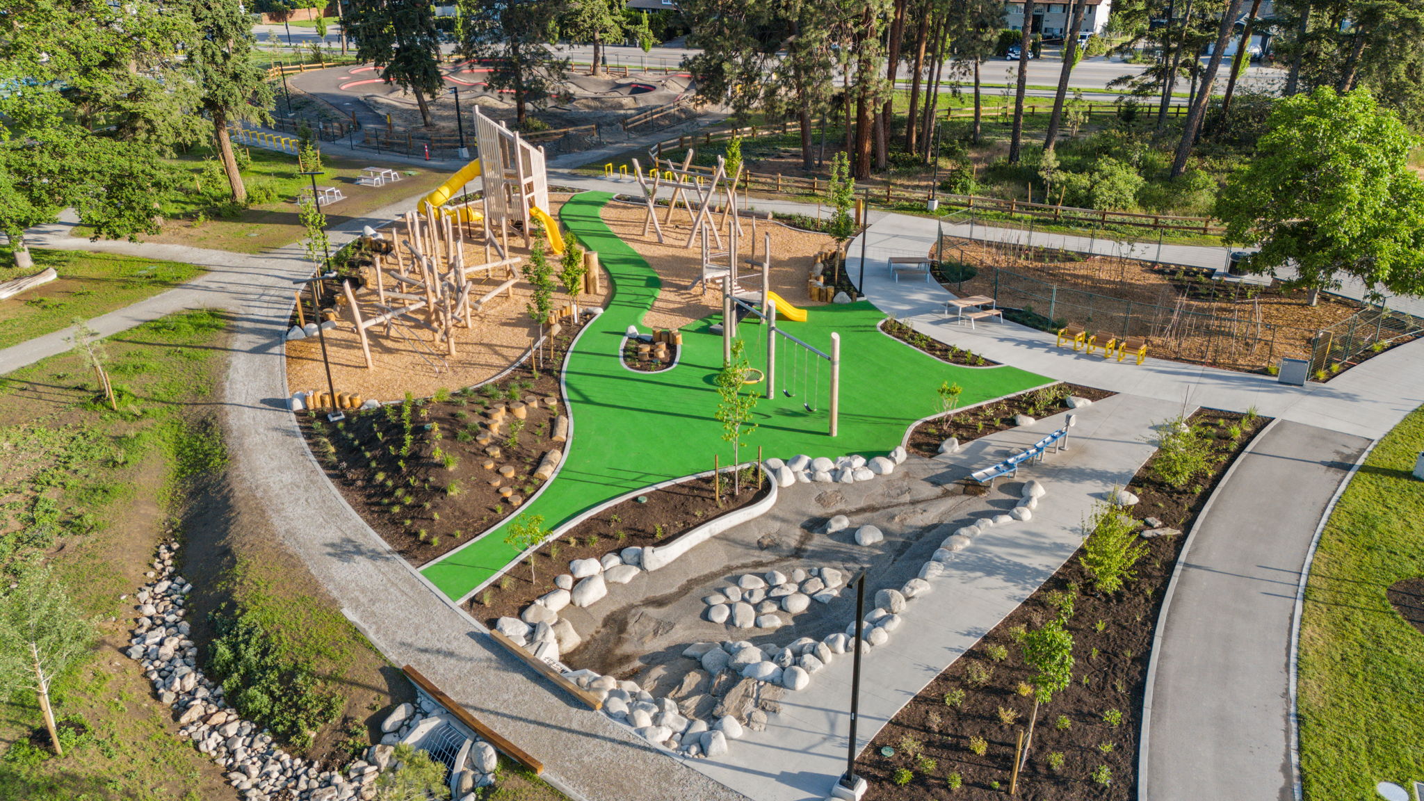 DeHart Community Park playground equipment in Kelowna, BC featuring multi-level play structures