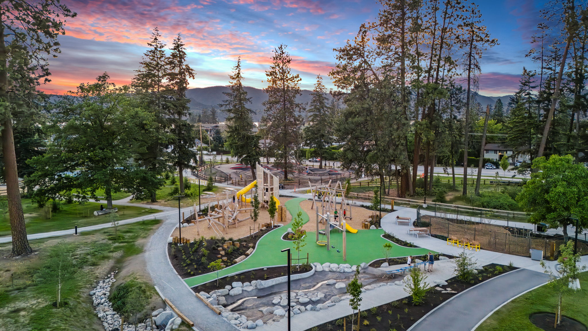DeHart Community Park playground equipment in Kelowna, BC featuring colorful play structures