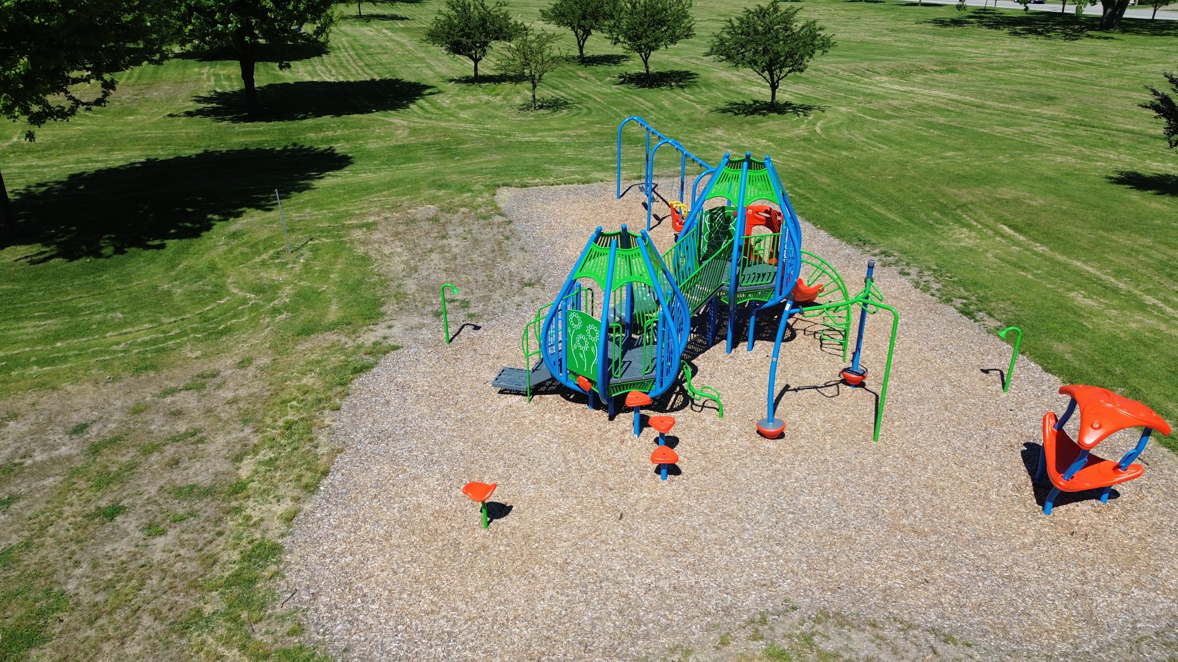 Newton Park playground equipment in Sarnia, ON showing swing sets and climbing areas
