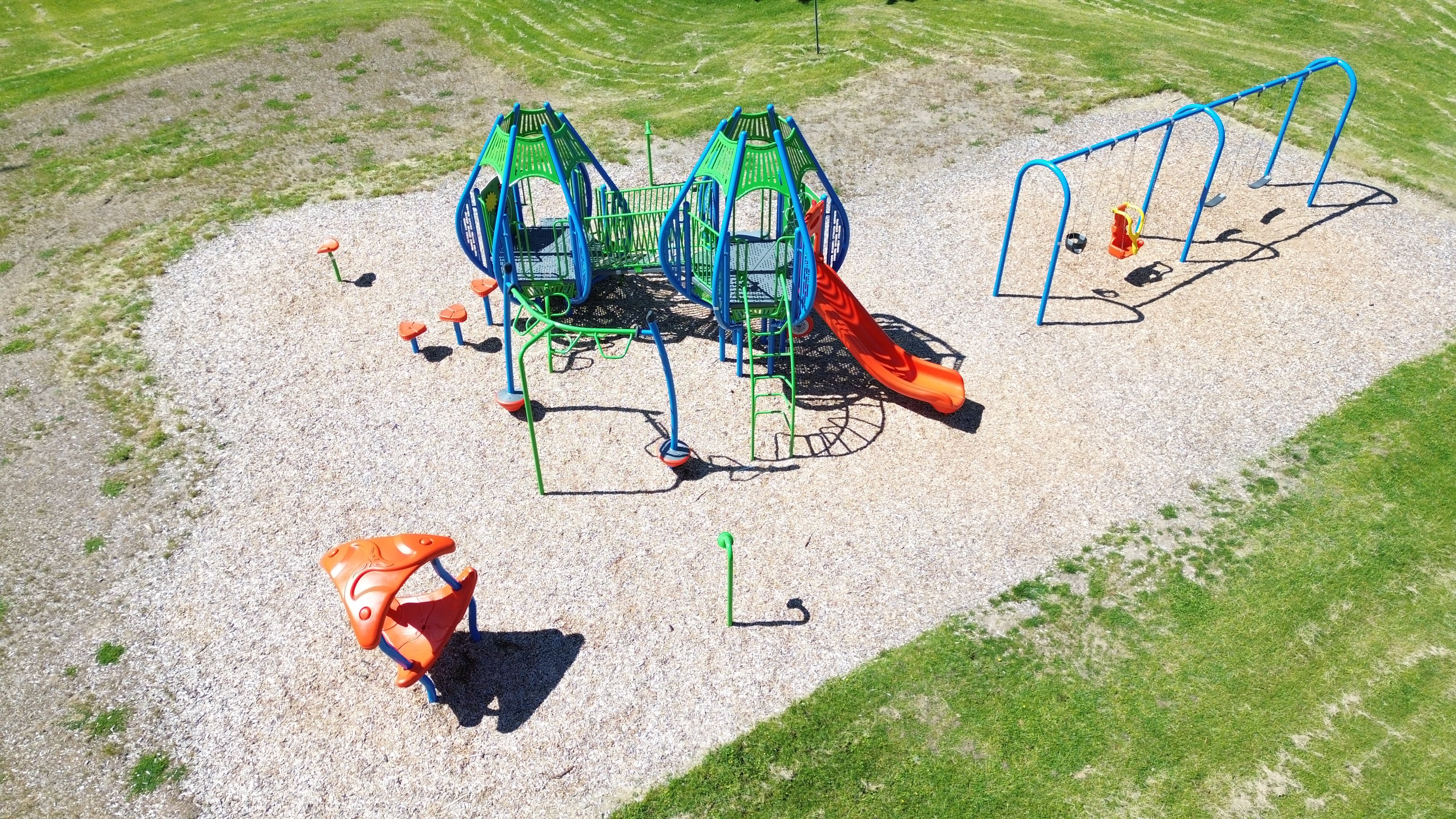 Newton Park playground equipment in Sarnia, ON featuring colorful play structures