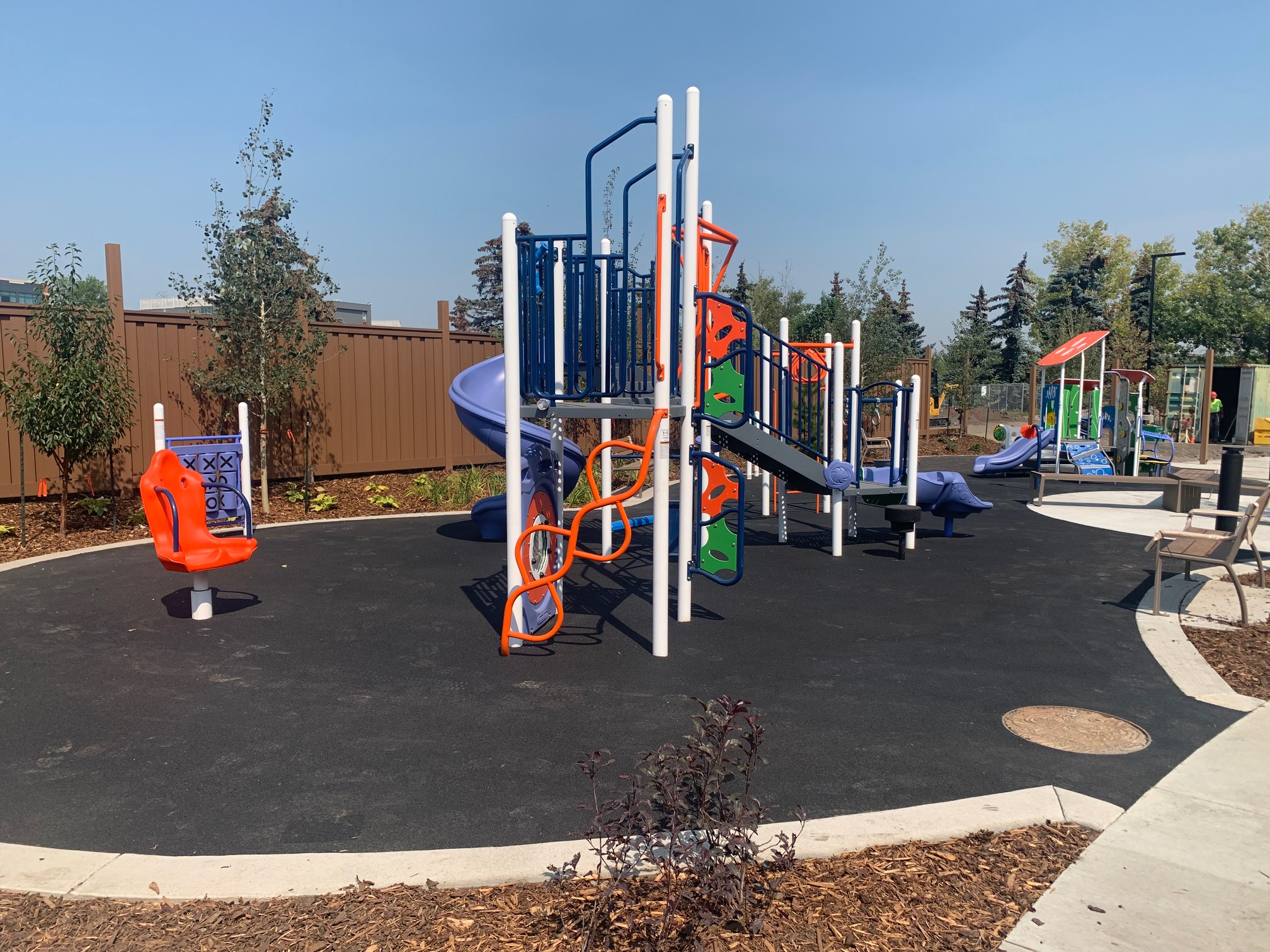 YW Sheriff King playground equipment in Calgary, AB featuring modern playground design