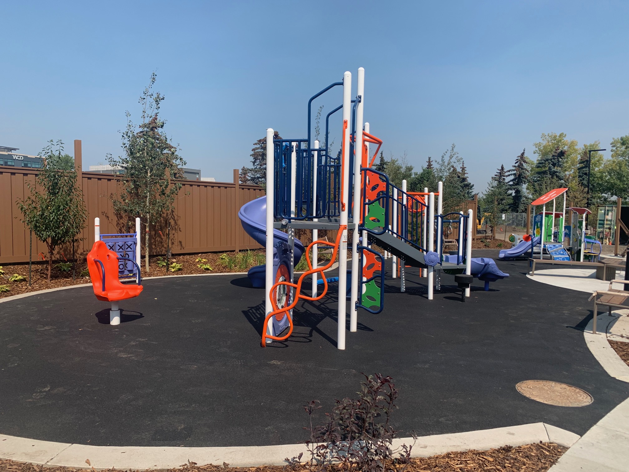 YW Sheriff King playground equipment in Calgary, AB showing accessible play equipment