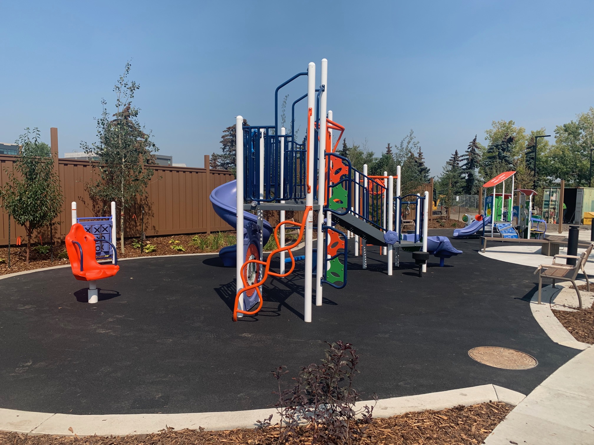 YW Sheriff King playground equipment in Calgary, AB with safety surfacing and equipment
