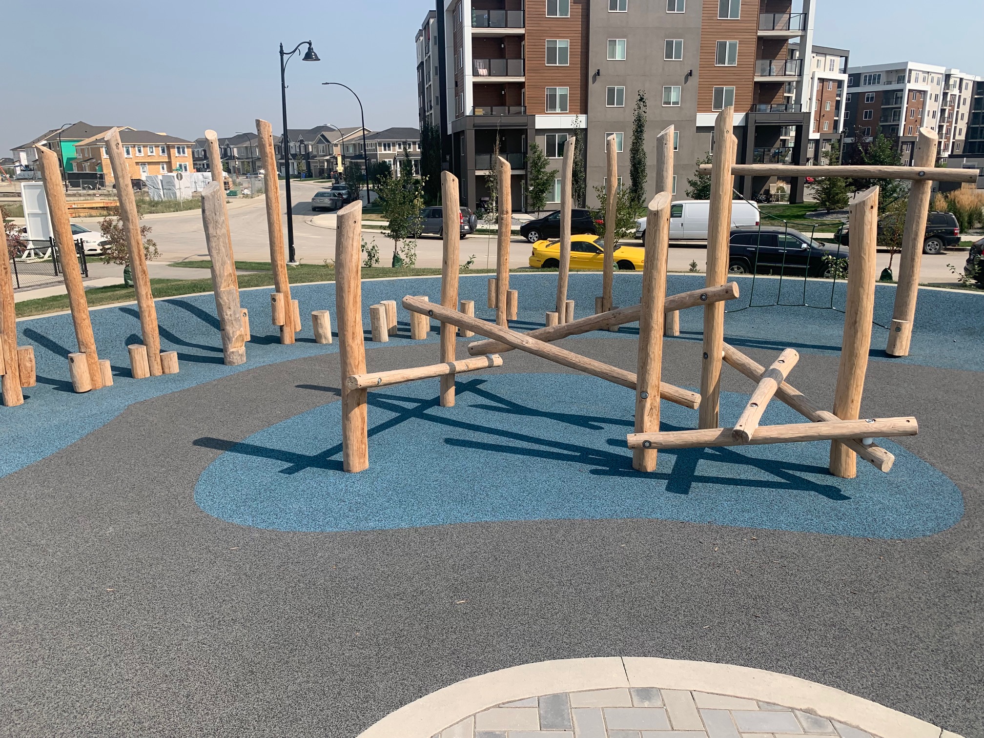 Yorkville Central Park playground equipment in Calgary, AB with safety surfacing and equipment