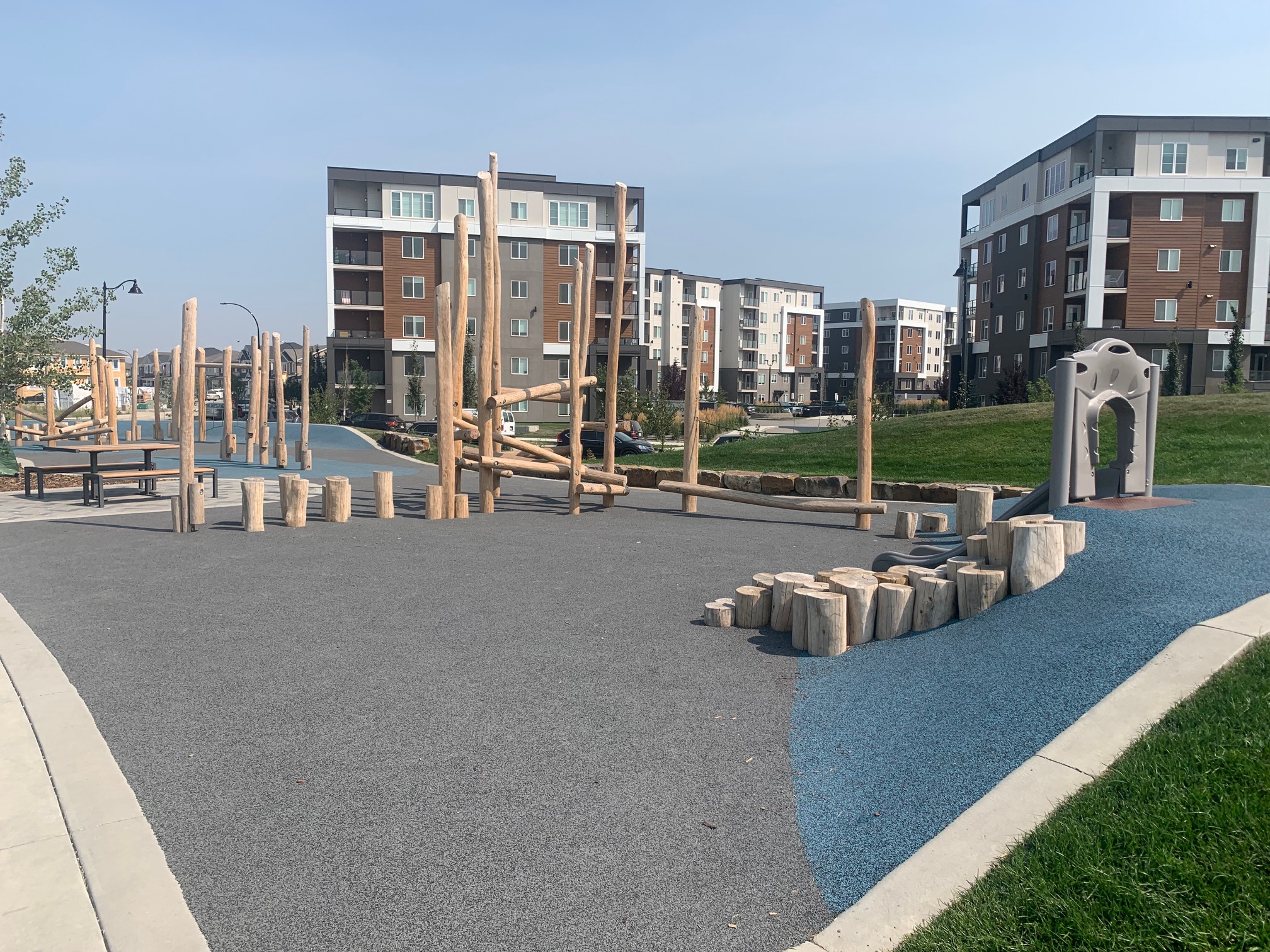 Yorkville Central Park playground equipment in Calgary, AB with climbing and sliding features