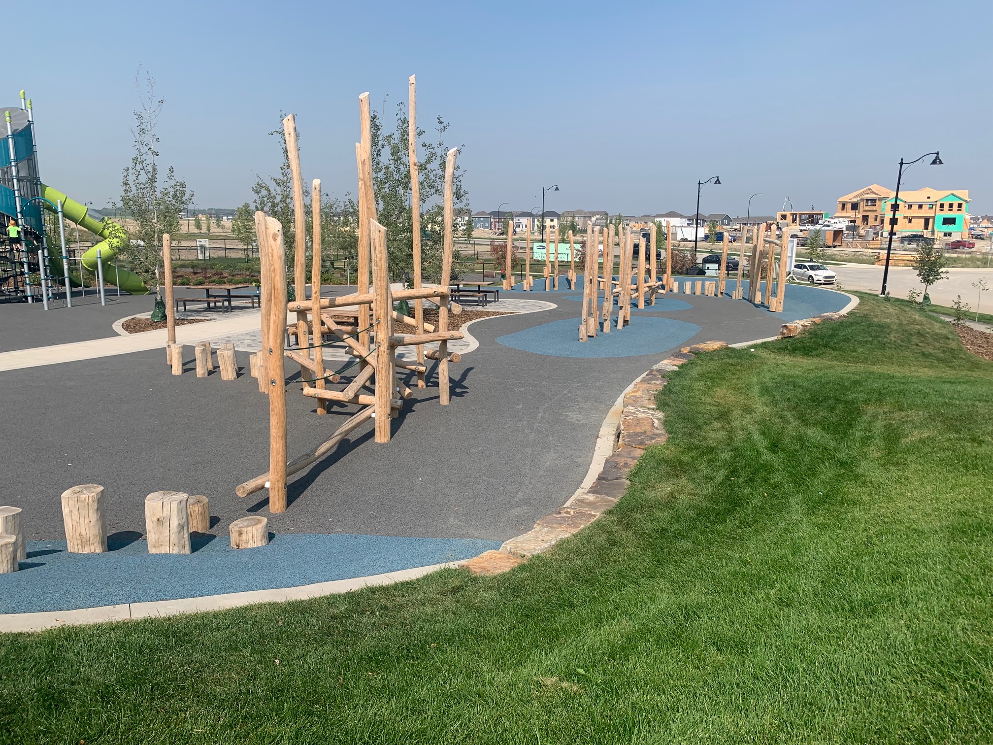 Yorkville Central Park playground equipment in Calgary, AB featuring colorful play structures