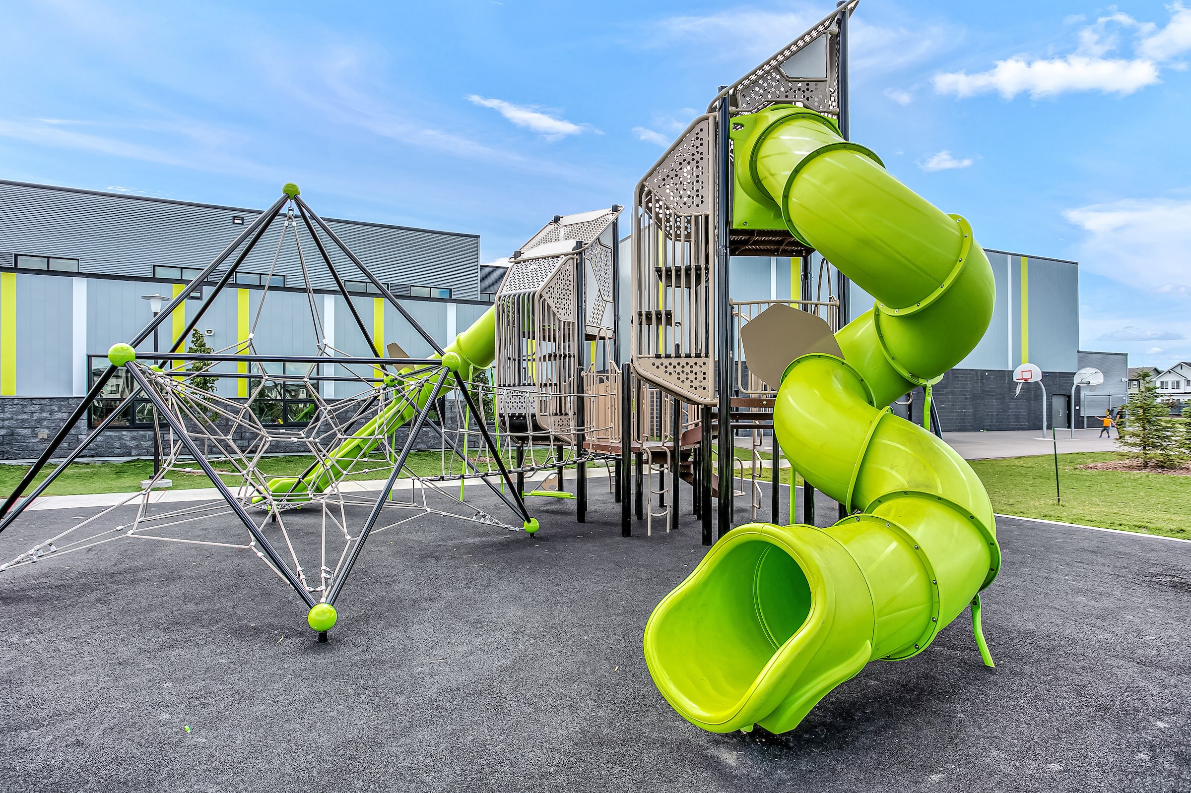 Joan Carr School playground equipment in Edmonton, AB with natural and built play elements
