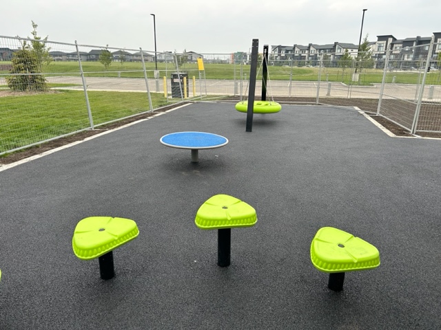 Joan Carr School playground equipment in Edmonton, AB with inclusive play features