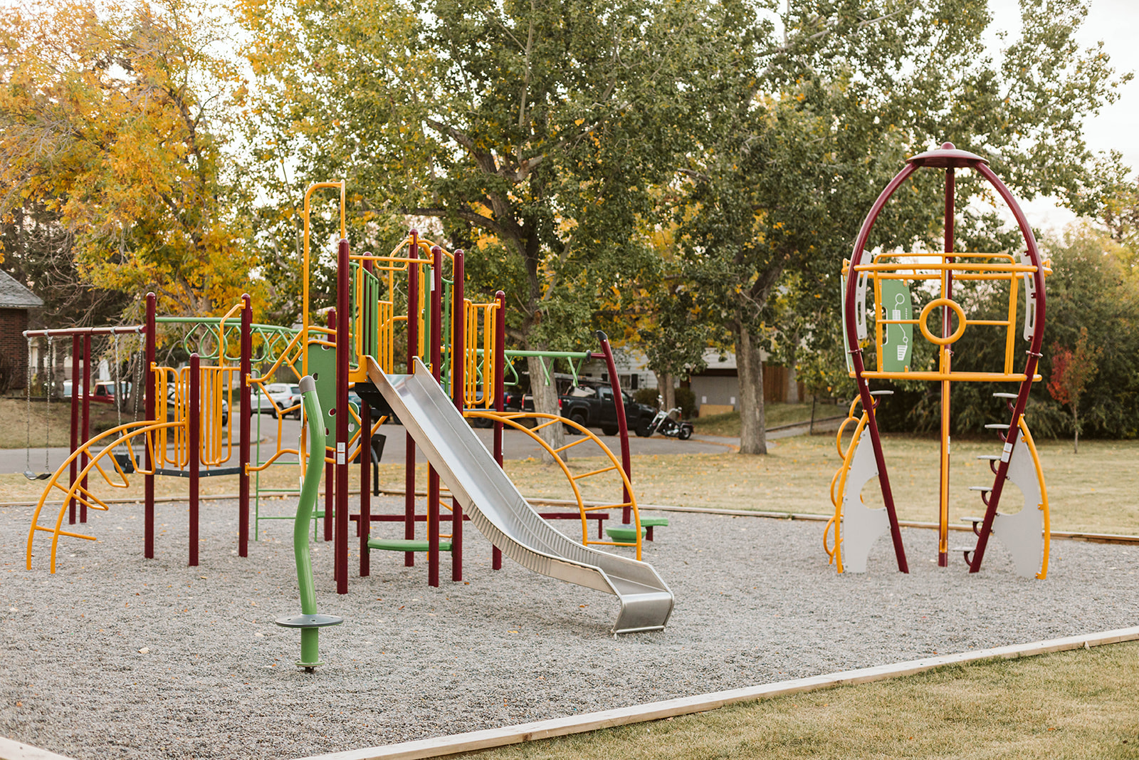 Marchand Park playground equipment in Calgary, AB showing community playground space
