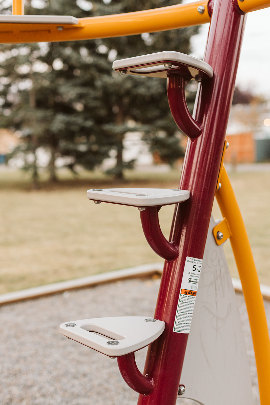 Marchand Park playground equipment in Calgary, AB with accessible ramps and platforms