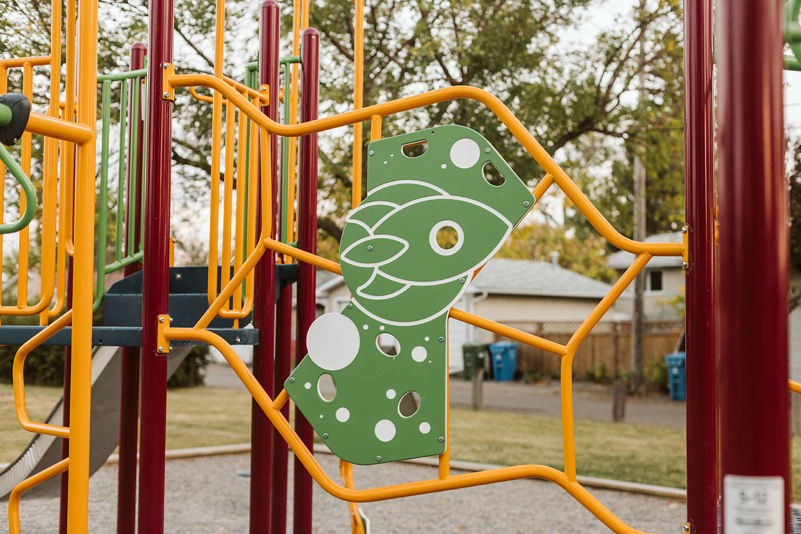 Marchand Park playground equipment in Calgary, AB with safety surfacing and equipment