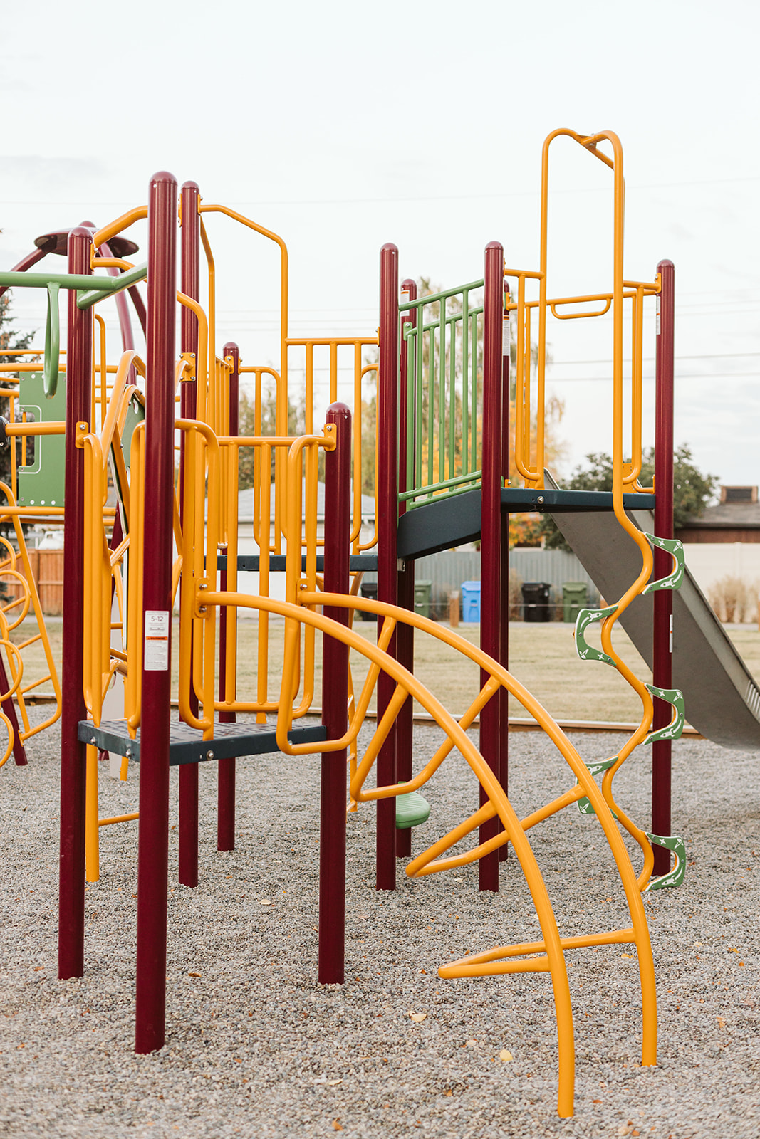 Marchand Park playground equipment in Calgary, AB showing swing sets and climbing areas