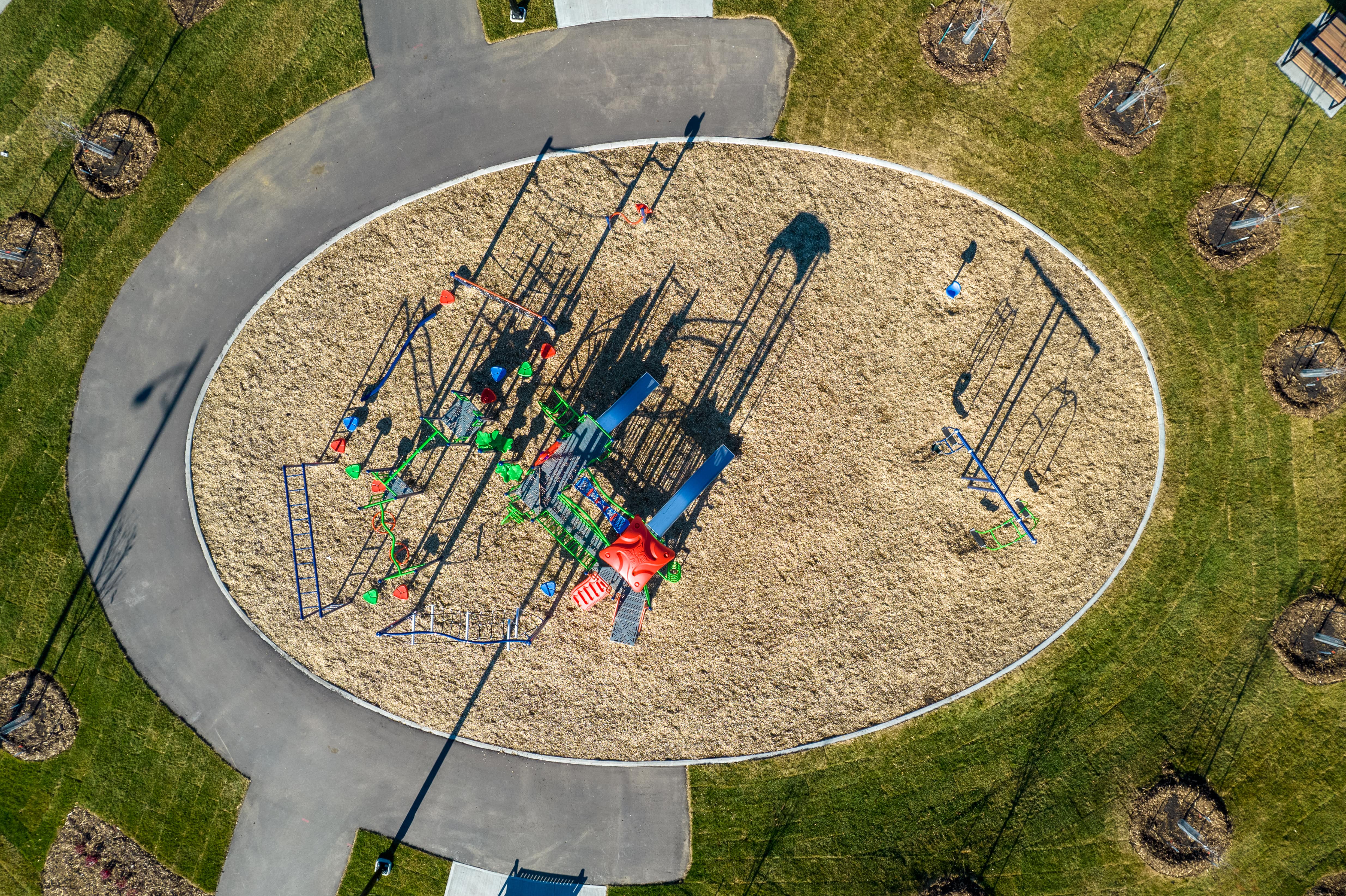 Aster Community Playground playground equipment in Edmonton, AB featuring slides and activity panels