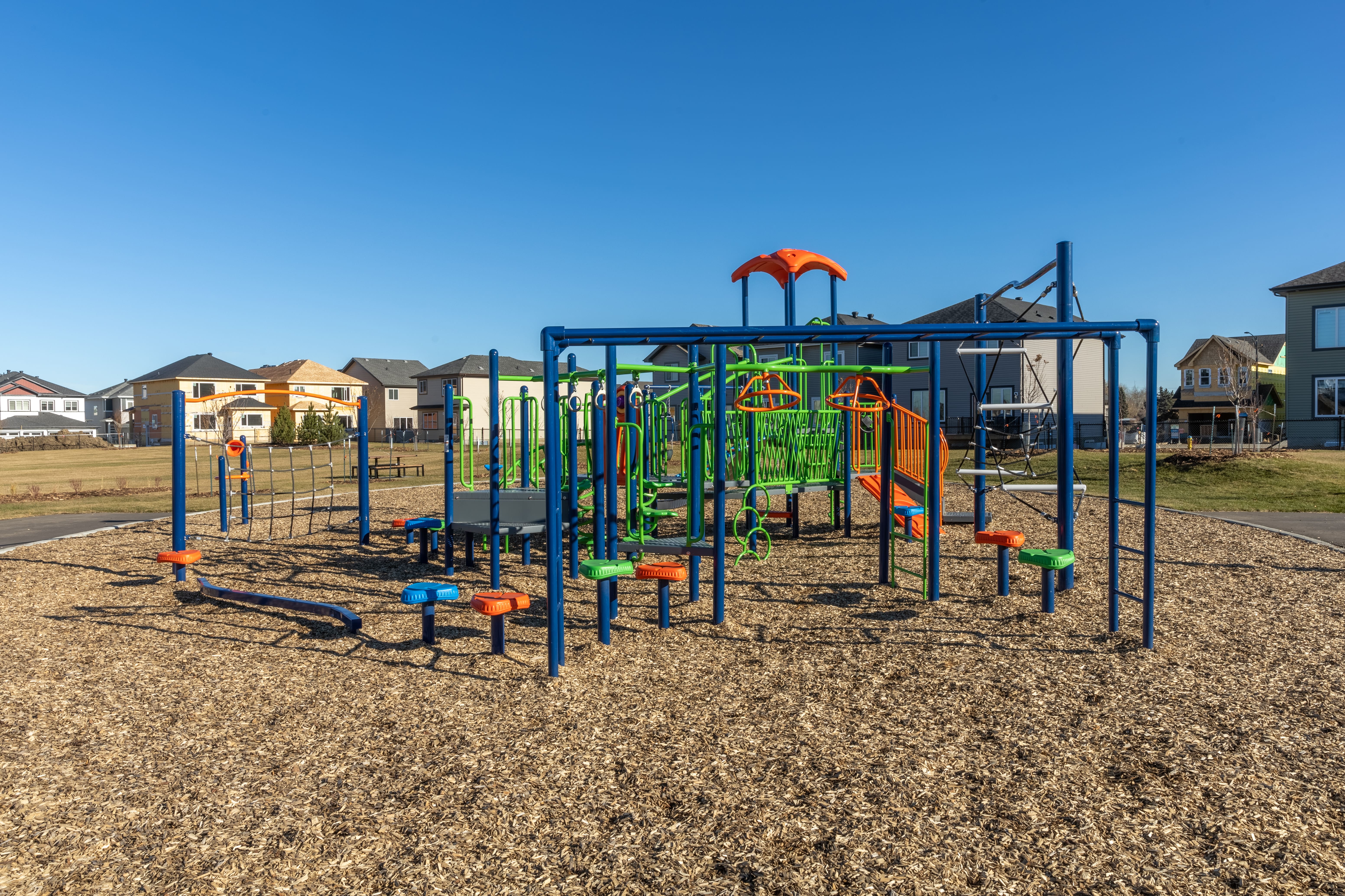 Aster Community Playground playground equipment in Edmonton, AB with climbing and sliding features