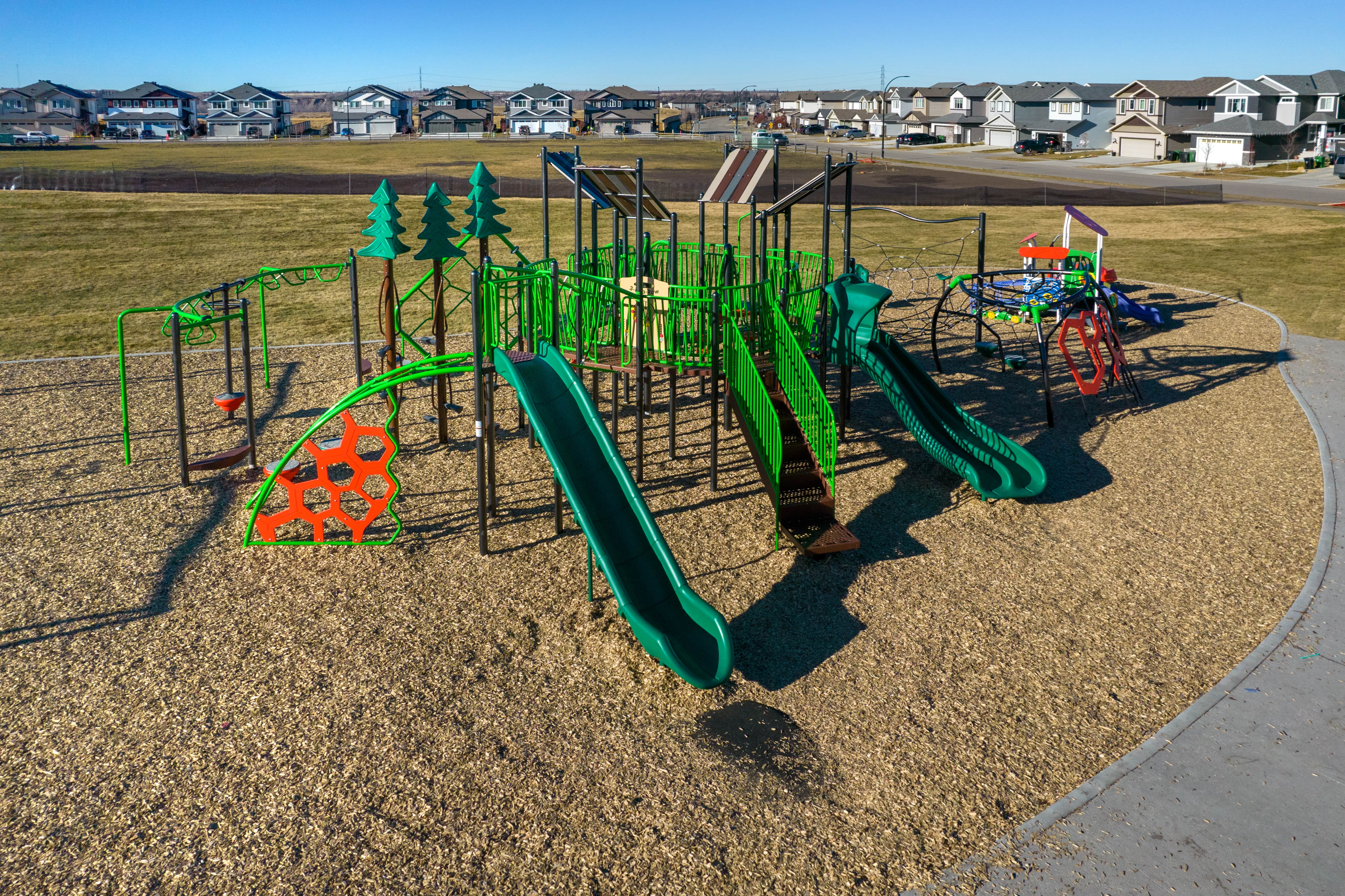 Forest Ridge playground equipment in Fort Saskatchewan, SK showing swing sets and climbing areas