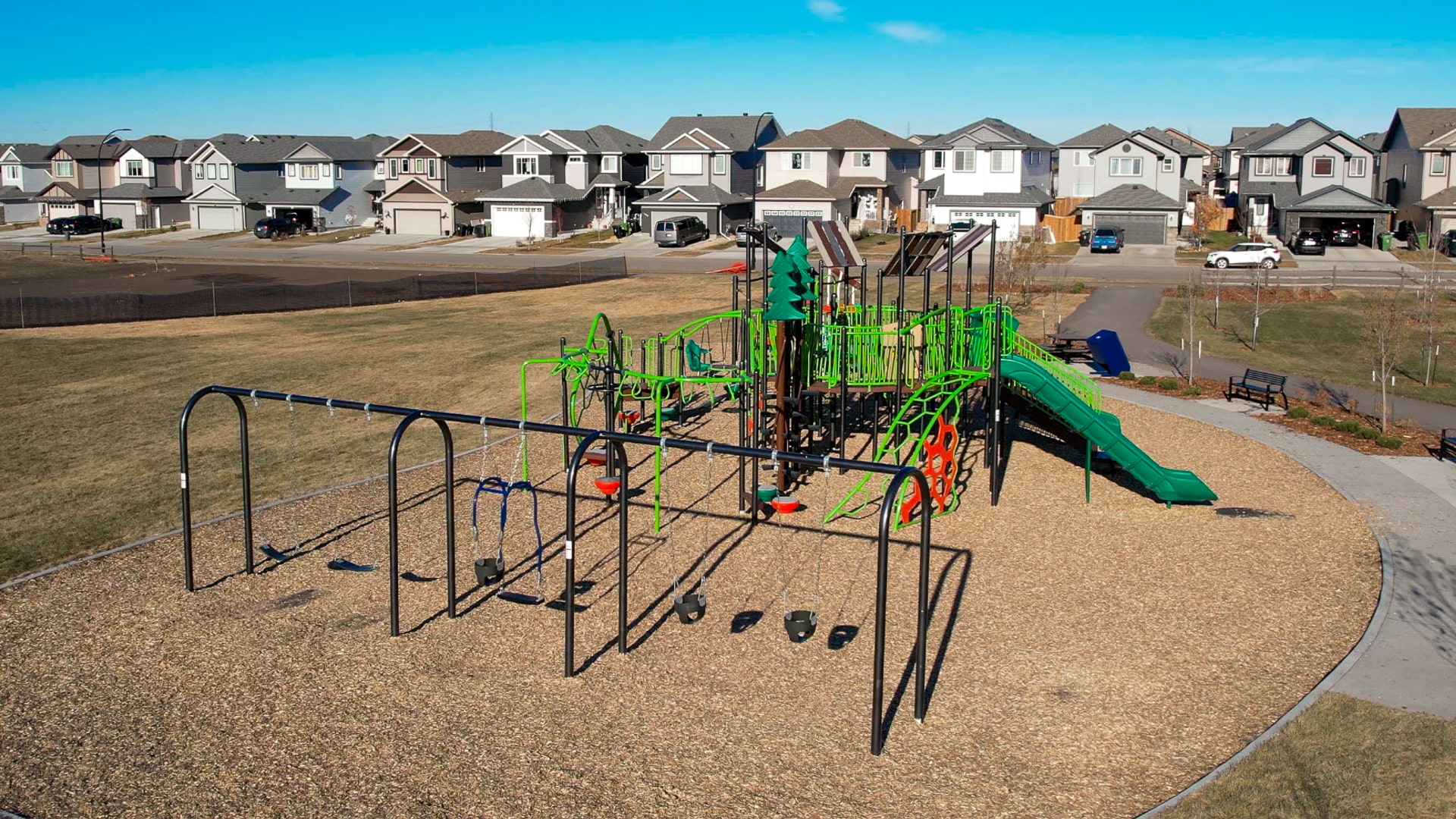 Forest Ridge playground equipment in Fort Saskatchewan, SK featuring slides and activity panels