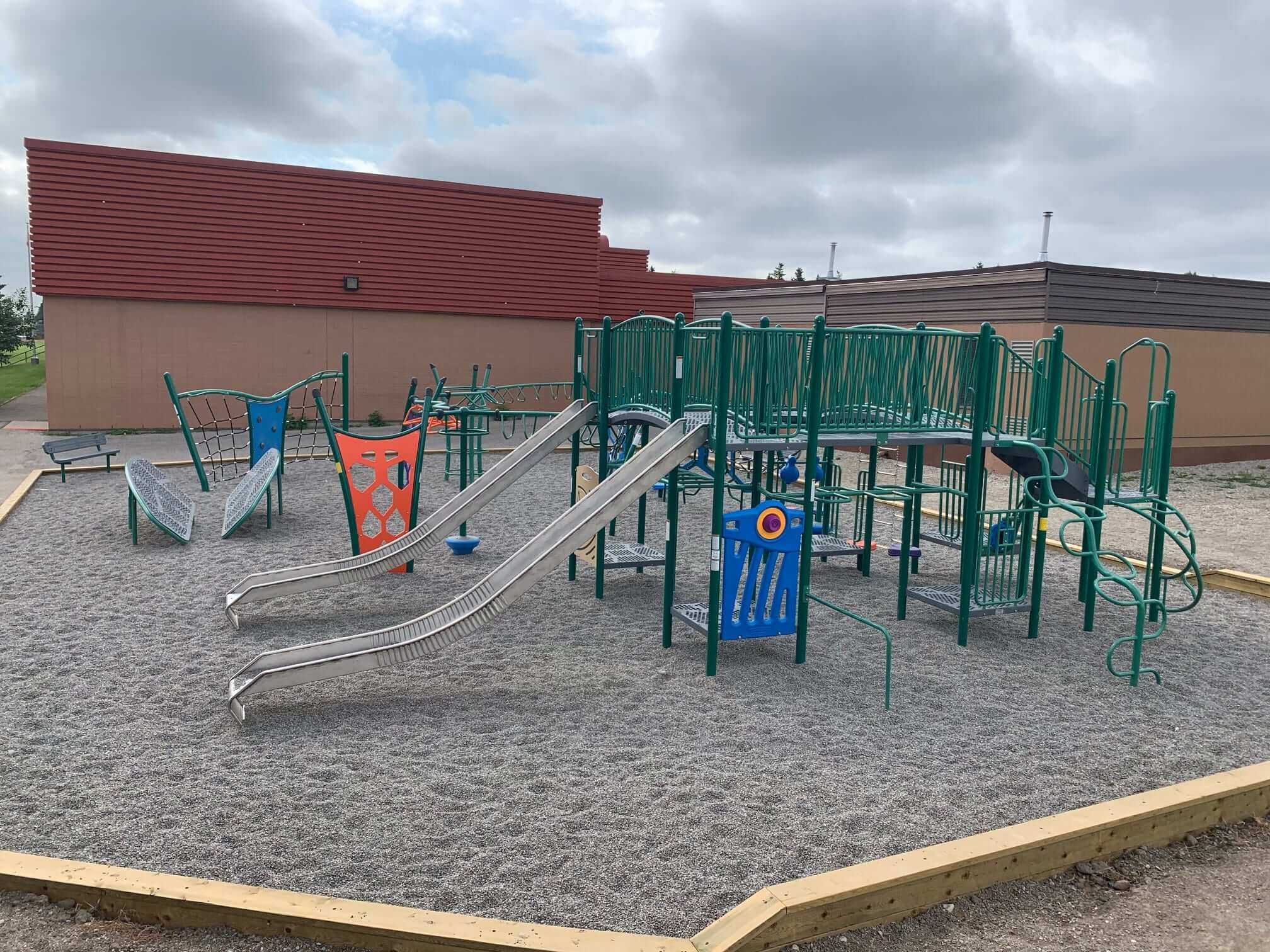 St. Bede's School Playground playground equipment in Calgary, AB featuring colorful play structures
