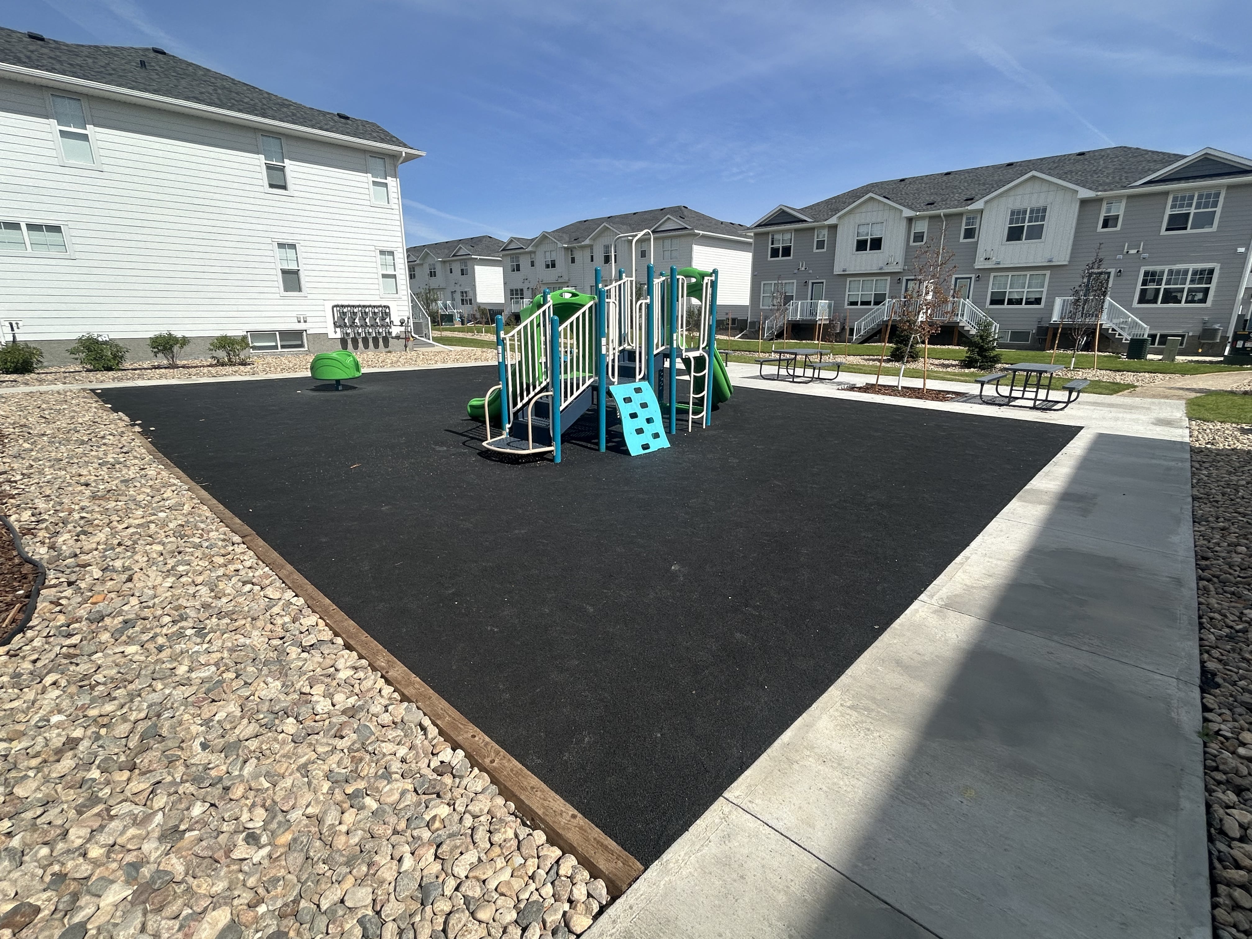 Windsor Park playground equipment in Regina, SK featuring slides and activity panels