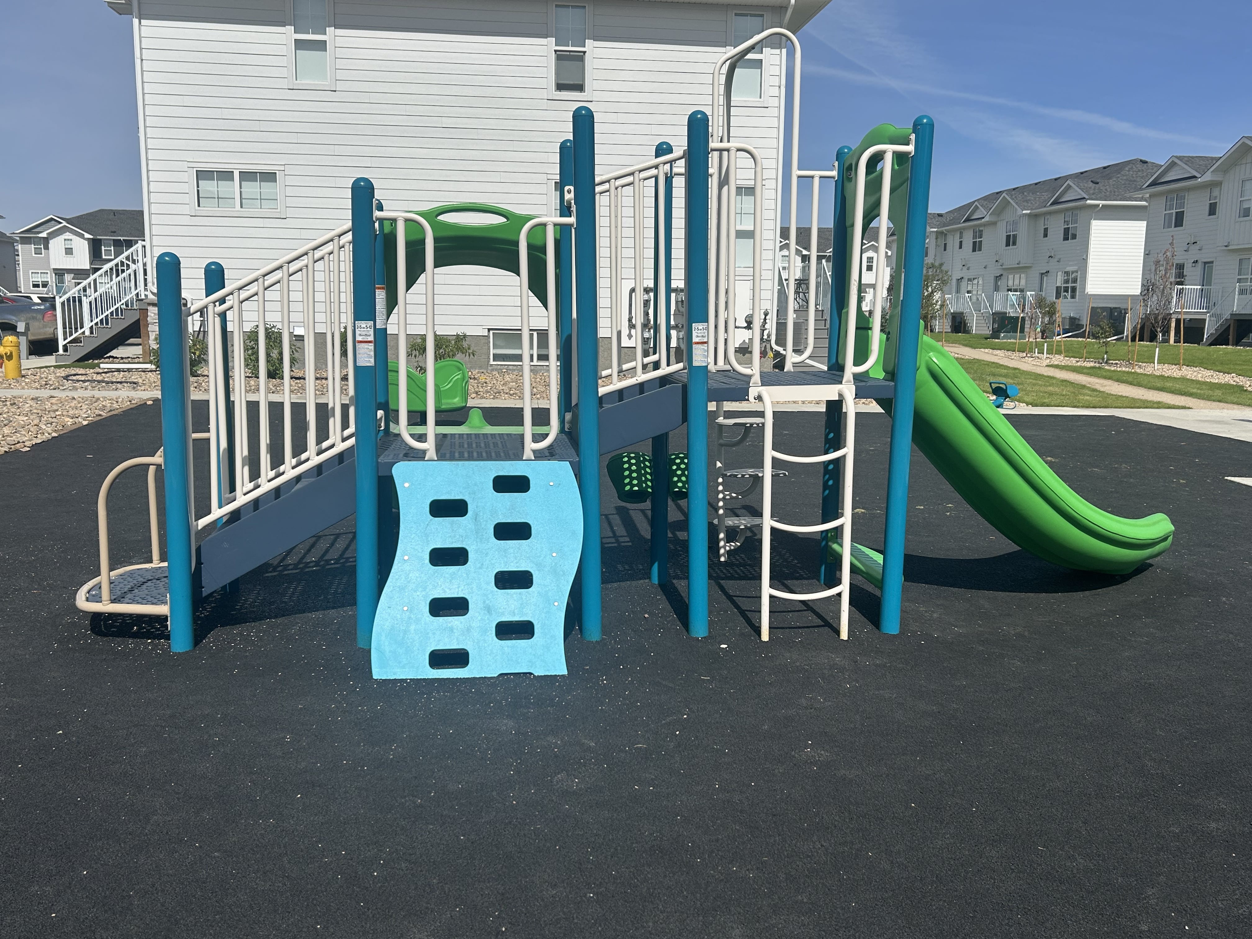 Windsor Park playground equipment in Regina, SK with natural and built play elements