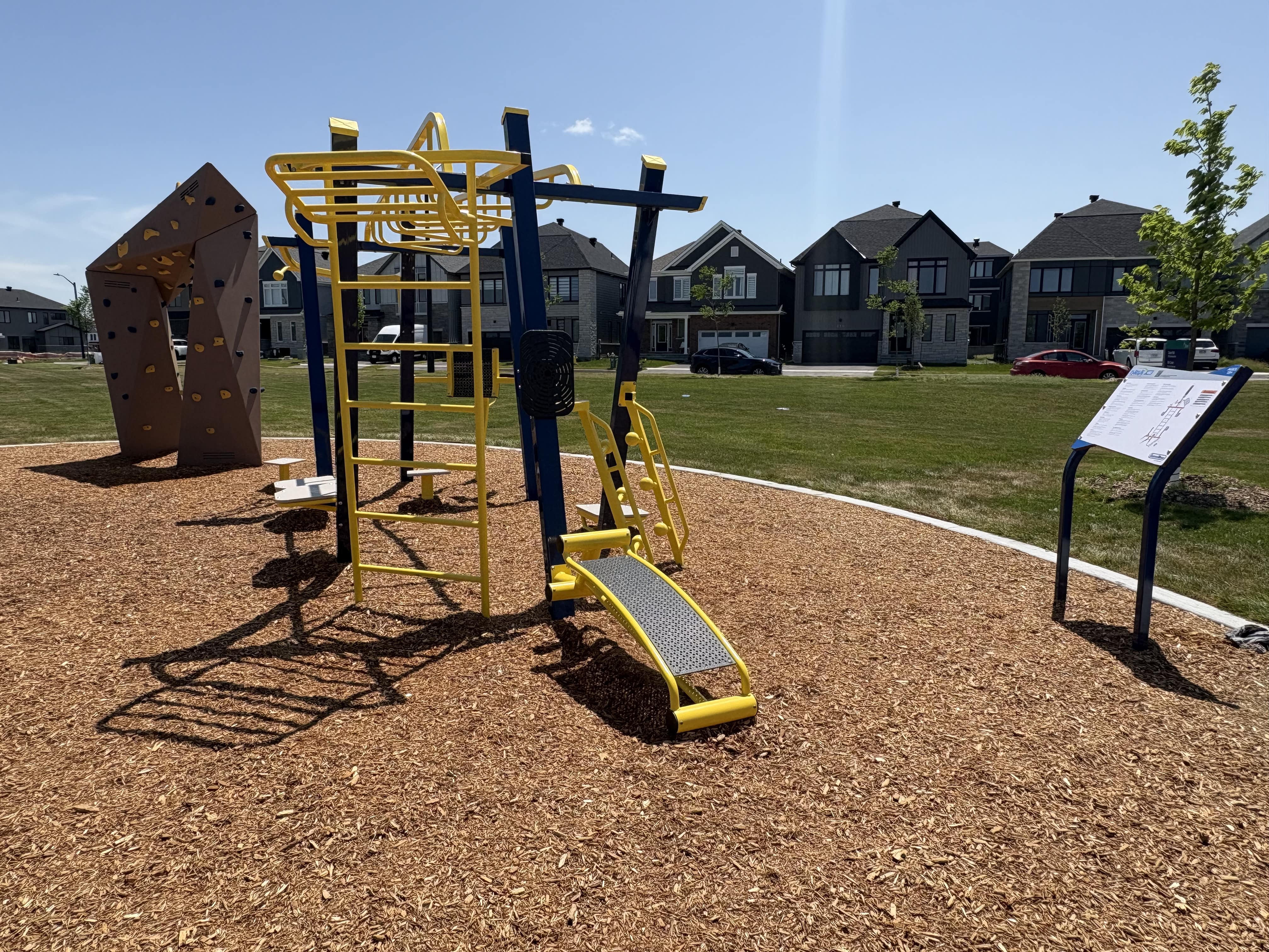Canoe Park Thrive 450 playground equipment in Ottawa, ON showing swing sets and climbing areas