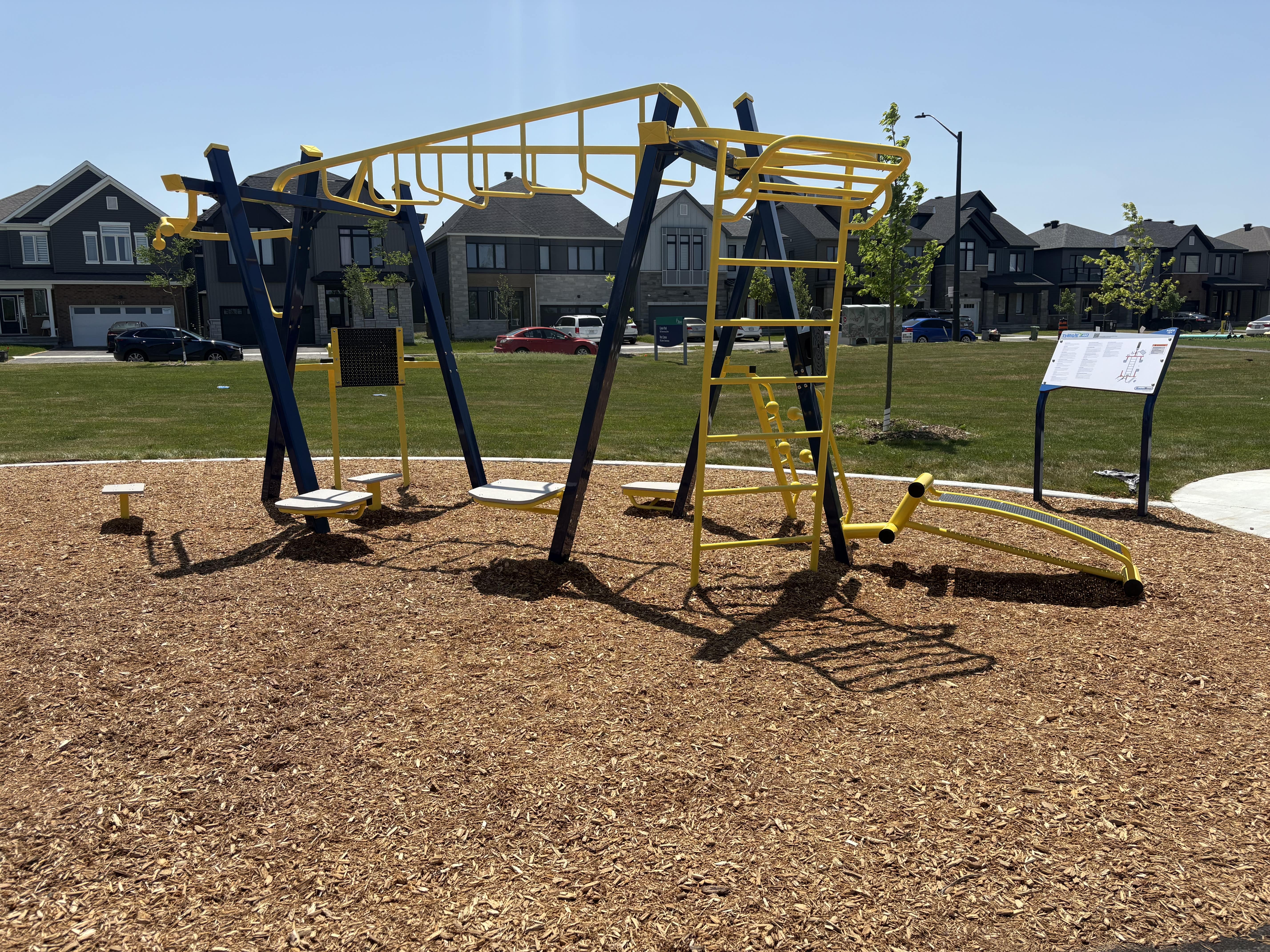 Canoe Park Thrive 450 playground equipment in Ottawa, ON featuring slides and activity panels