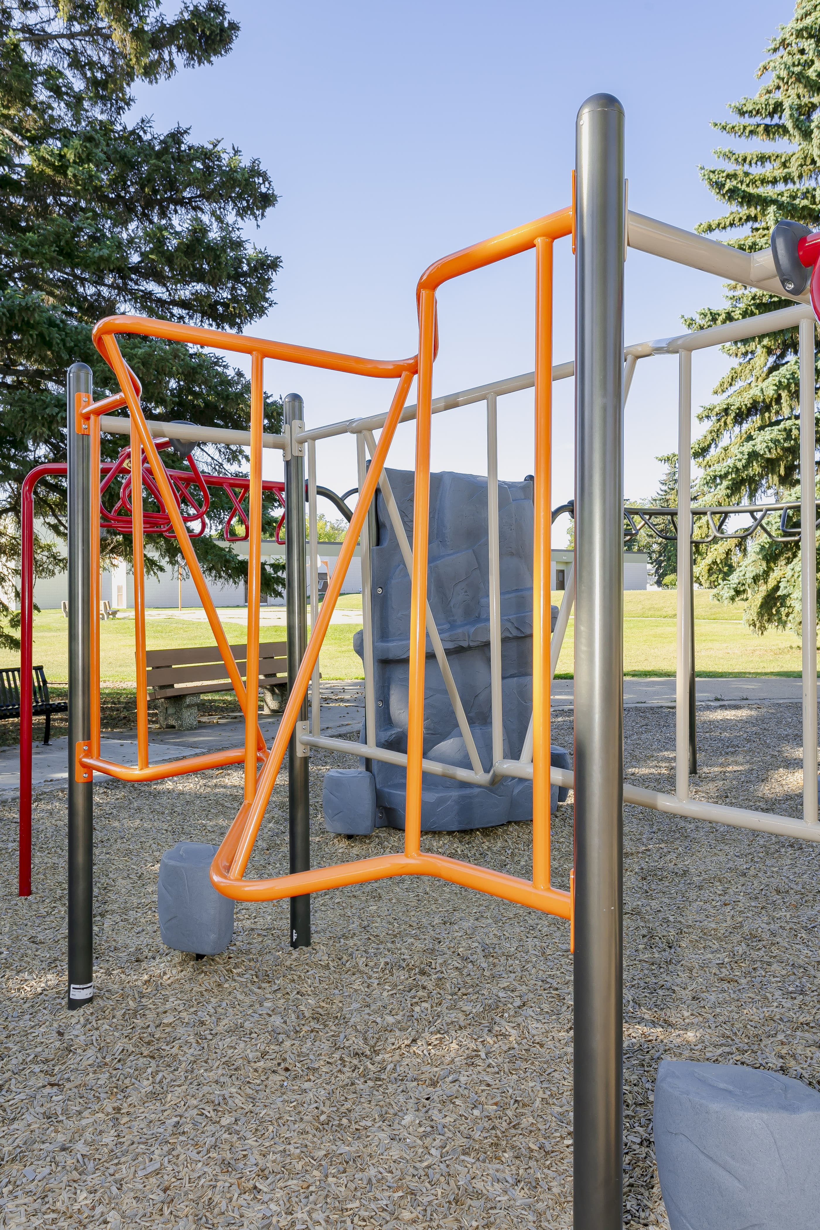 Rundle Heights Community Playground playground equipment in Edmonton, AB showing swing sets and climbing areas