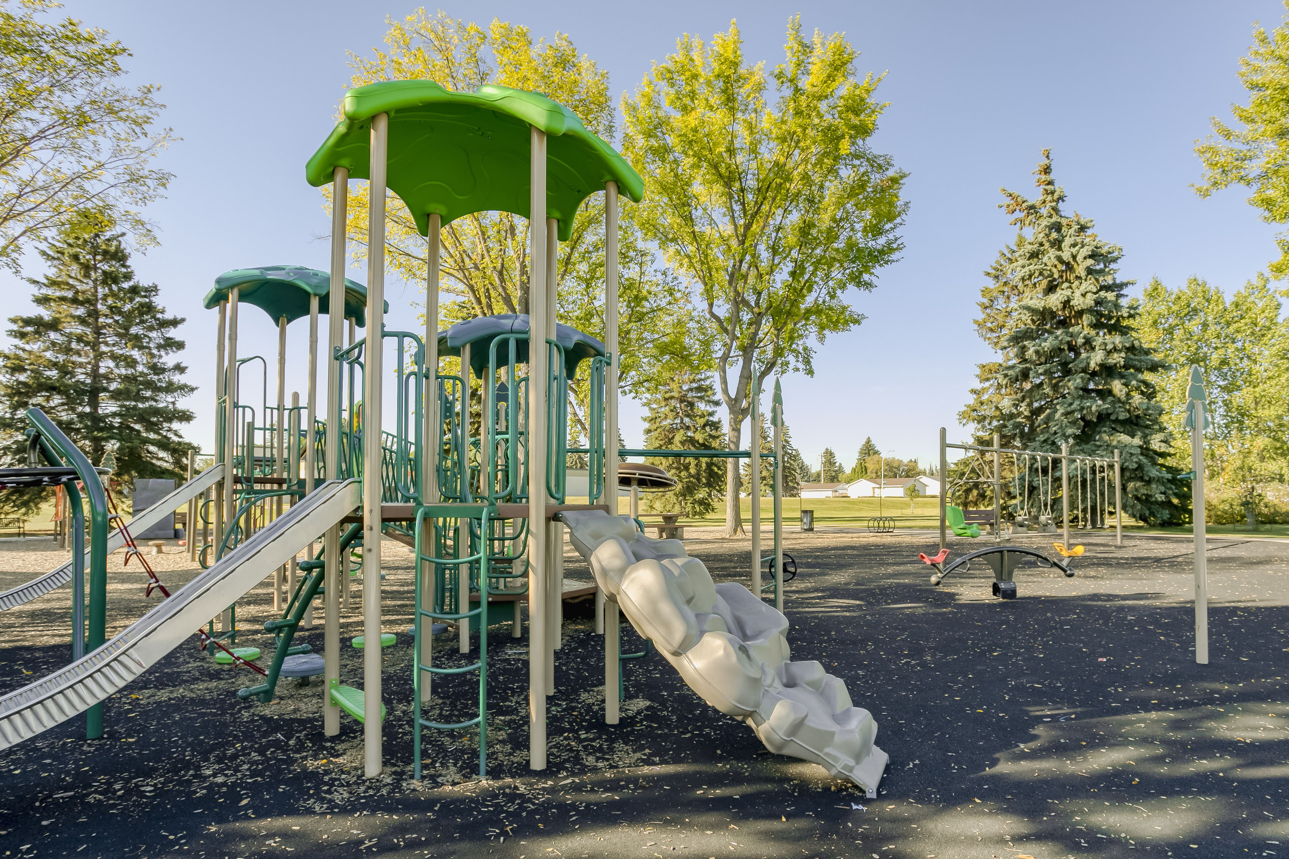 Rundle Heights Community Playground playground equipment in Edmonton, AB with safety surfacing and equipment