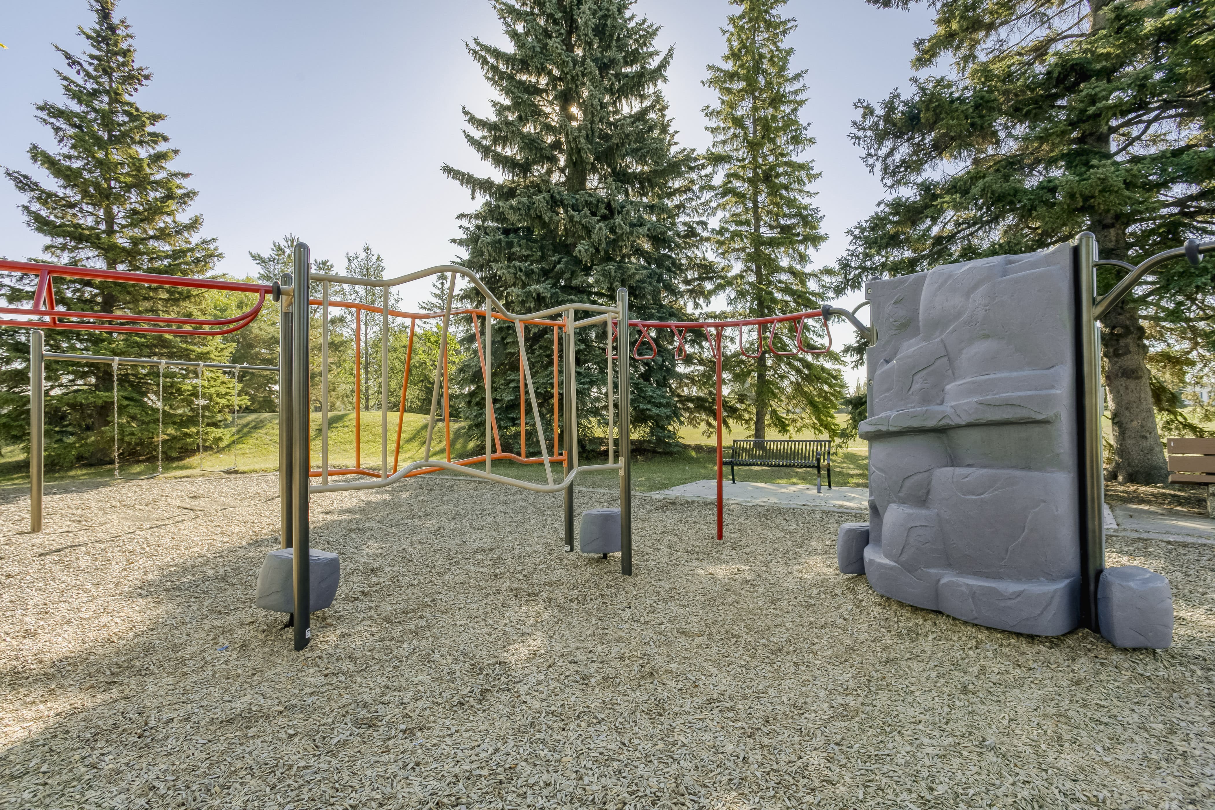 Rundle Heights Community Playground playground equipment in Edmonton, AB showing accessible play equipment