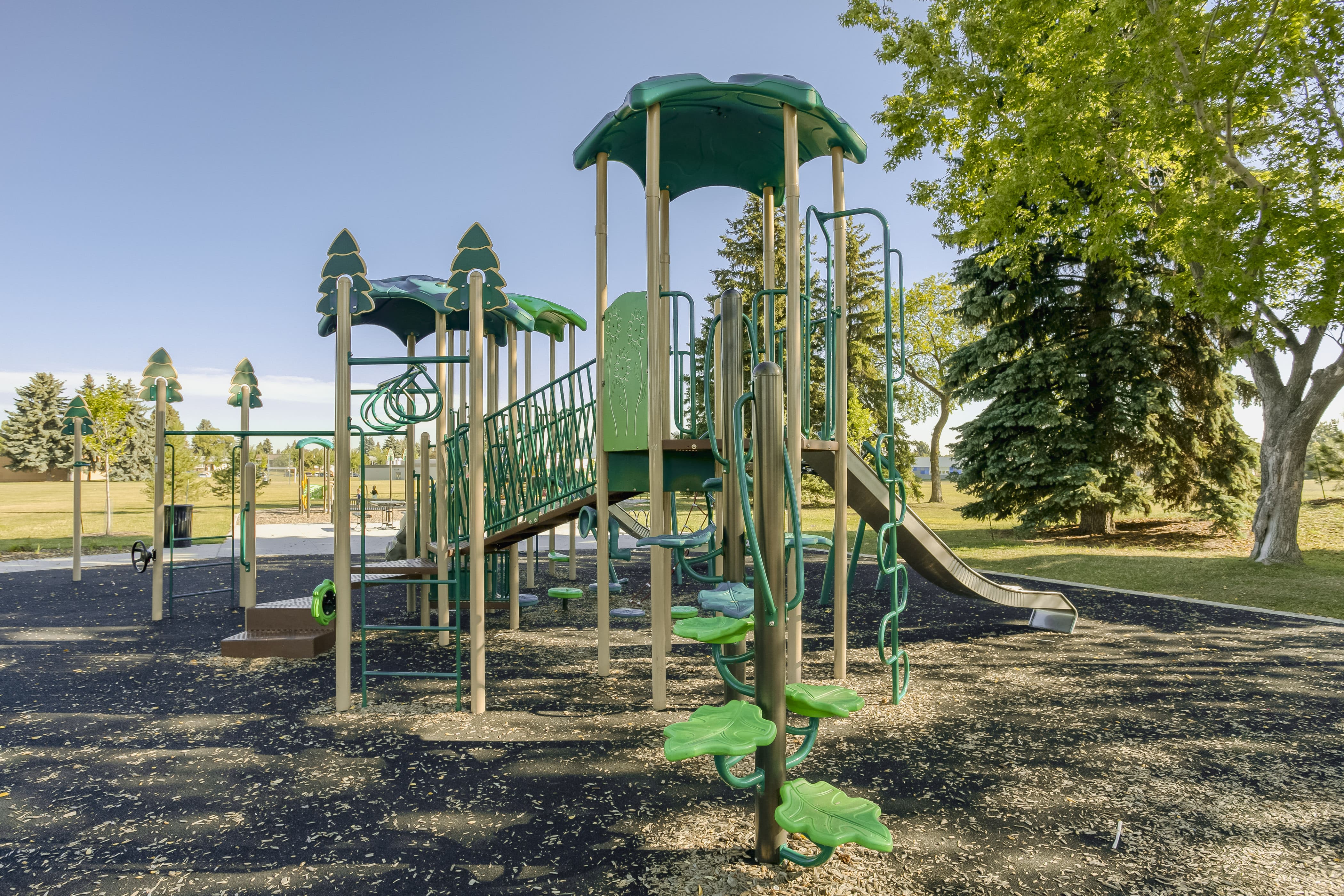 Rundle Heights Community Playground playground equipment in Edmonton, AB with assorted climbing features