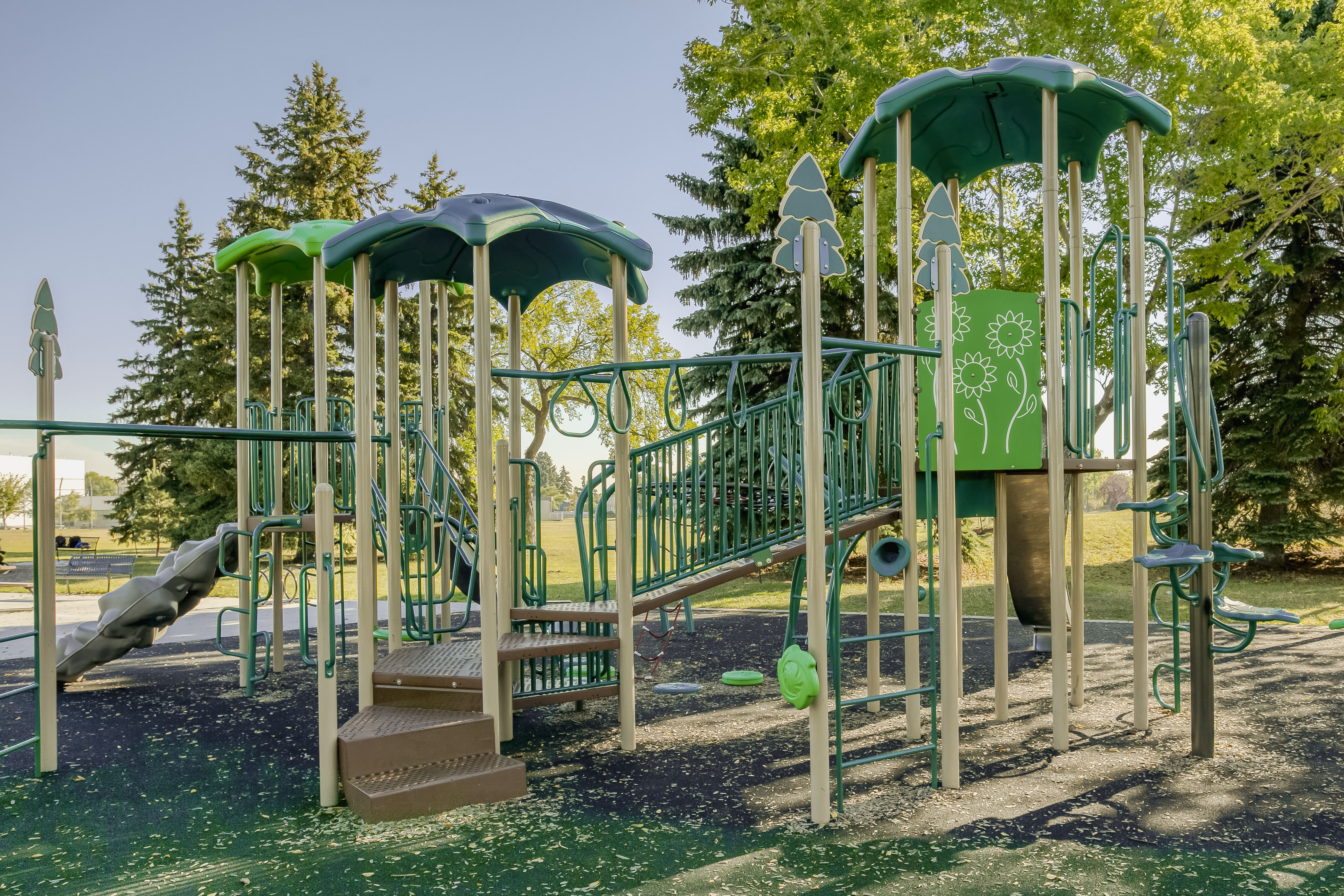 Rundle Heights Community Playground playground equipment in Edmonton, AB with natural and built play elements