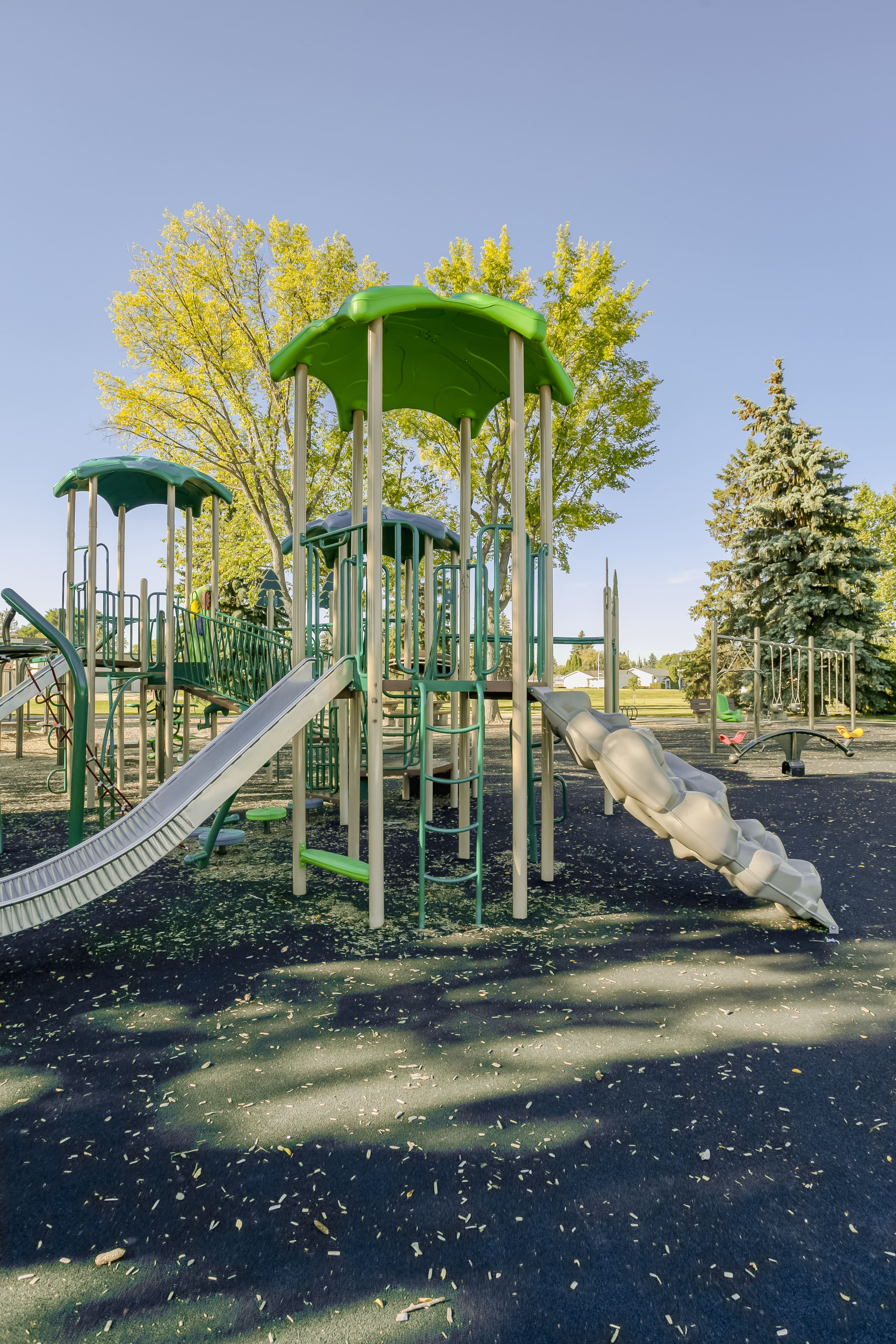 Rundle Heights Community Playground playground equipment in Edmonton, AB featuring multiple climbing structures